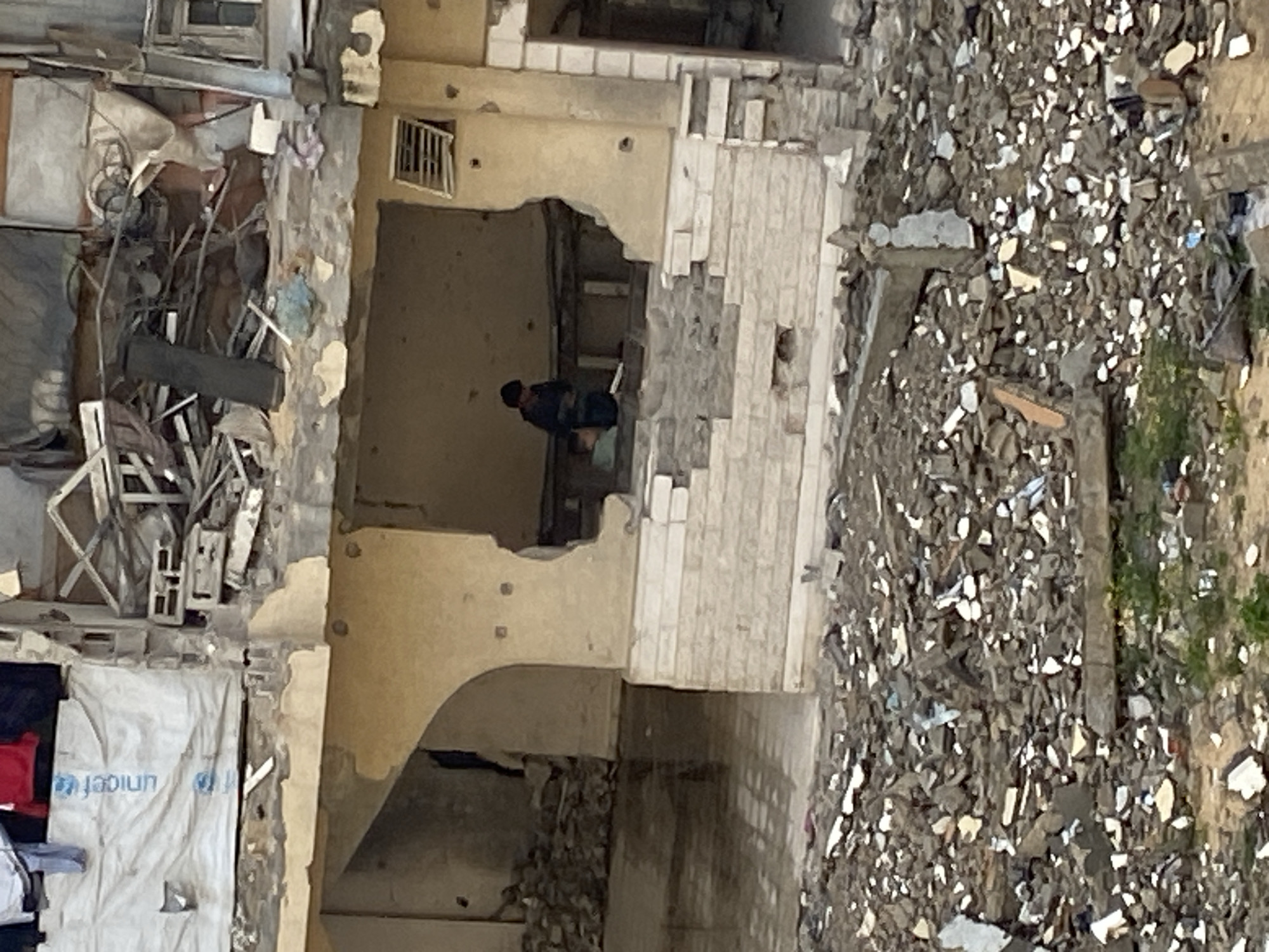 Children play amid damaged buildings in Khan Yunis