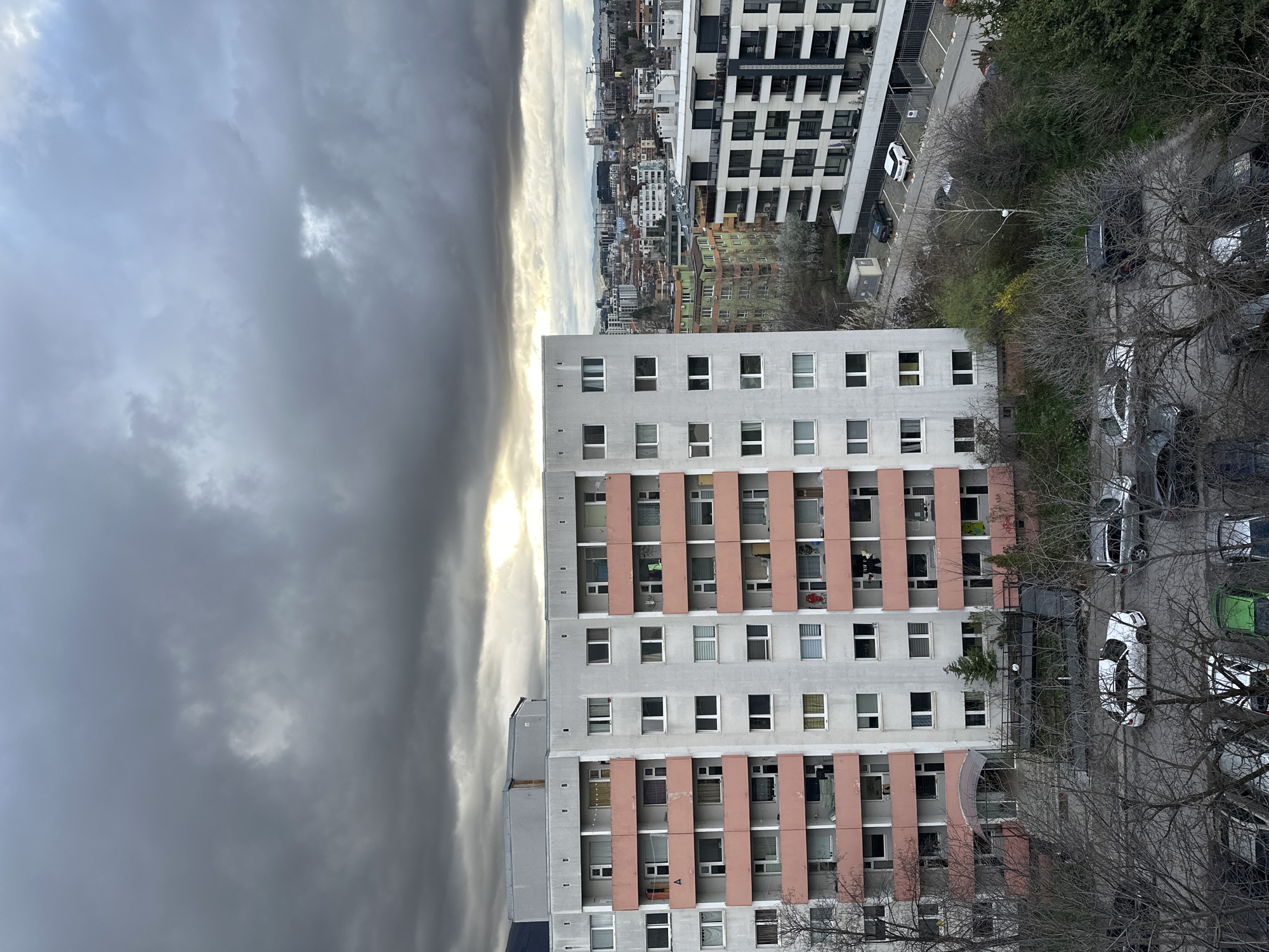 Afternoon sunlight breaks through clouds over Sofia residential area