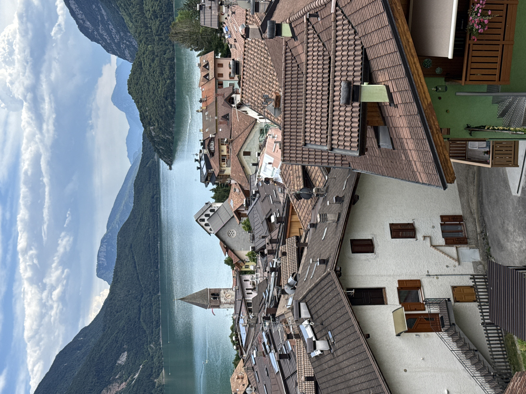 Molveno's flower-filled streets and mountain backdrop, mid-afternoon.