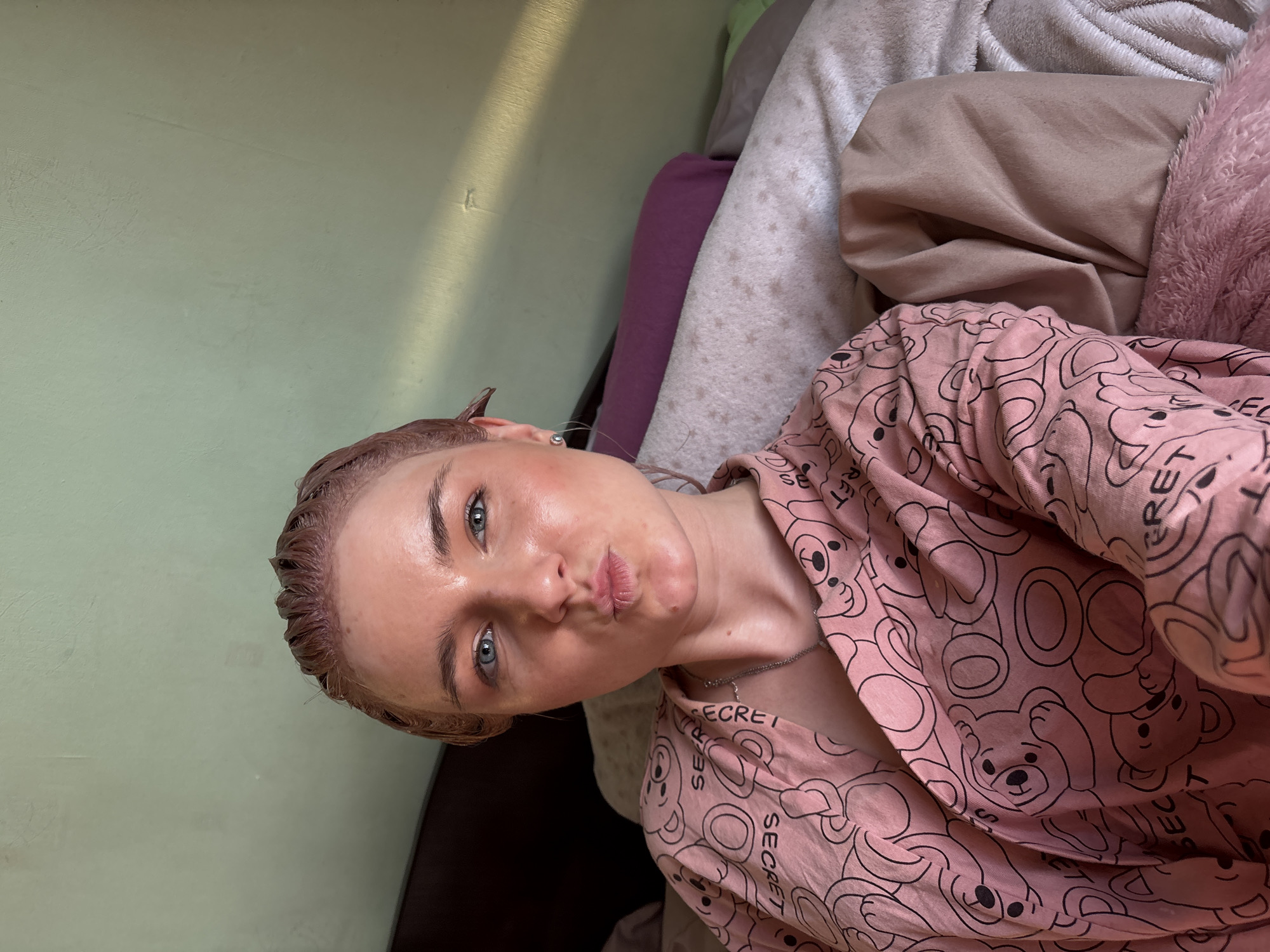 Woman documents hair treatment routine in bedroom selfies