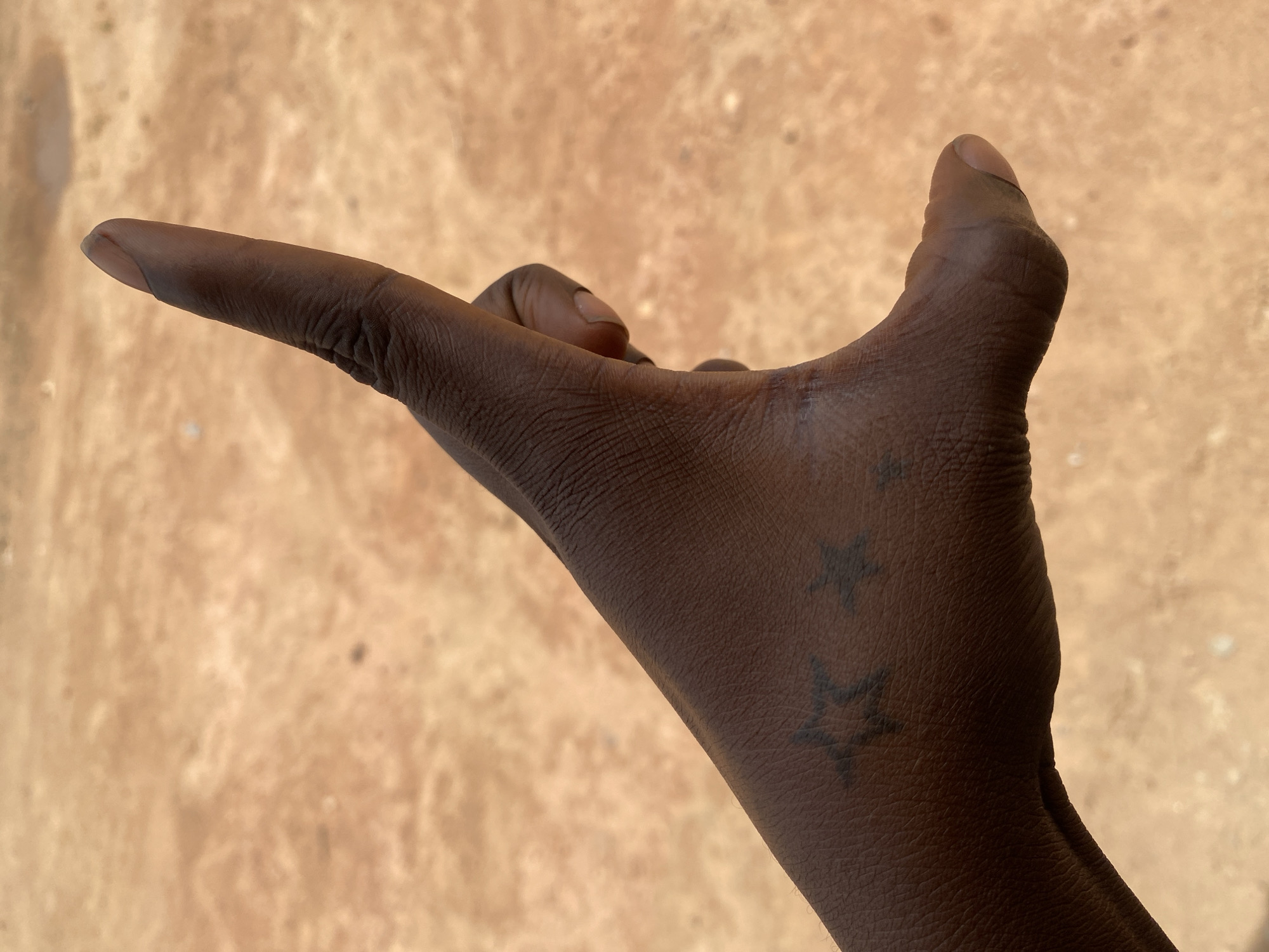 Hand gesture and skyward view documented in Rido, Nigeria