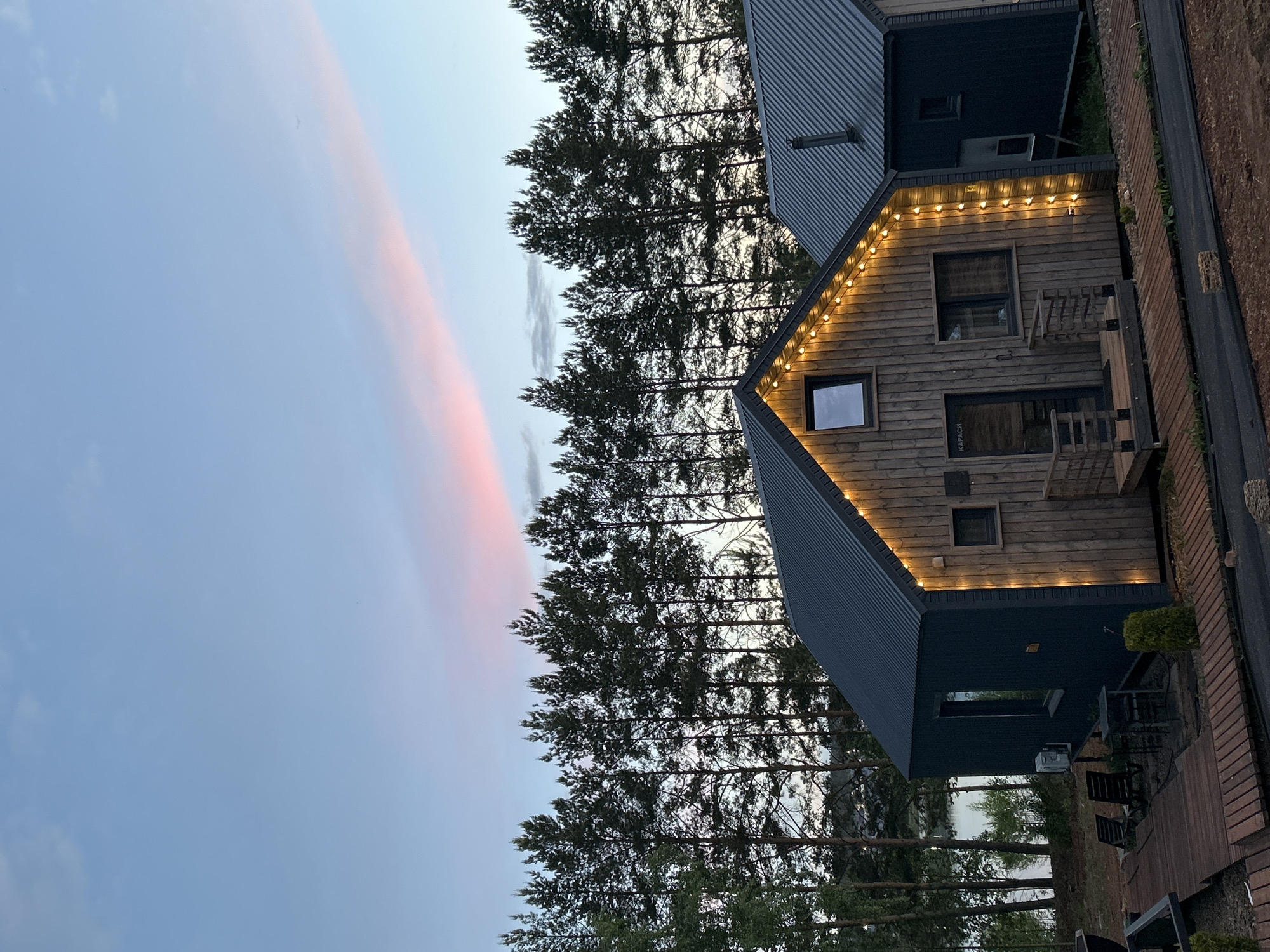 Wooden resort cabins observed at sunset in Pirogovo, Russia