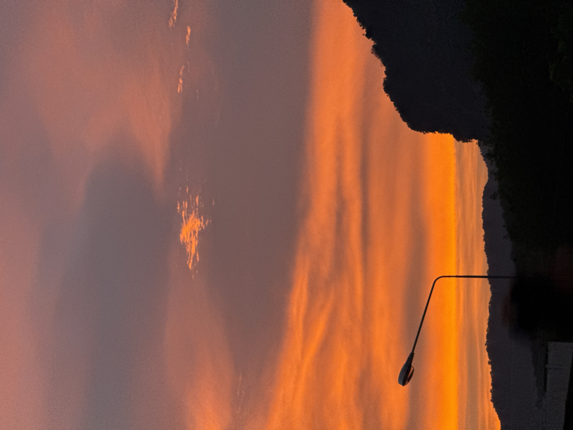 Vivid sunset over Ban Na Tin with mountain silhouette