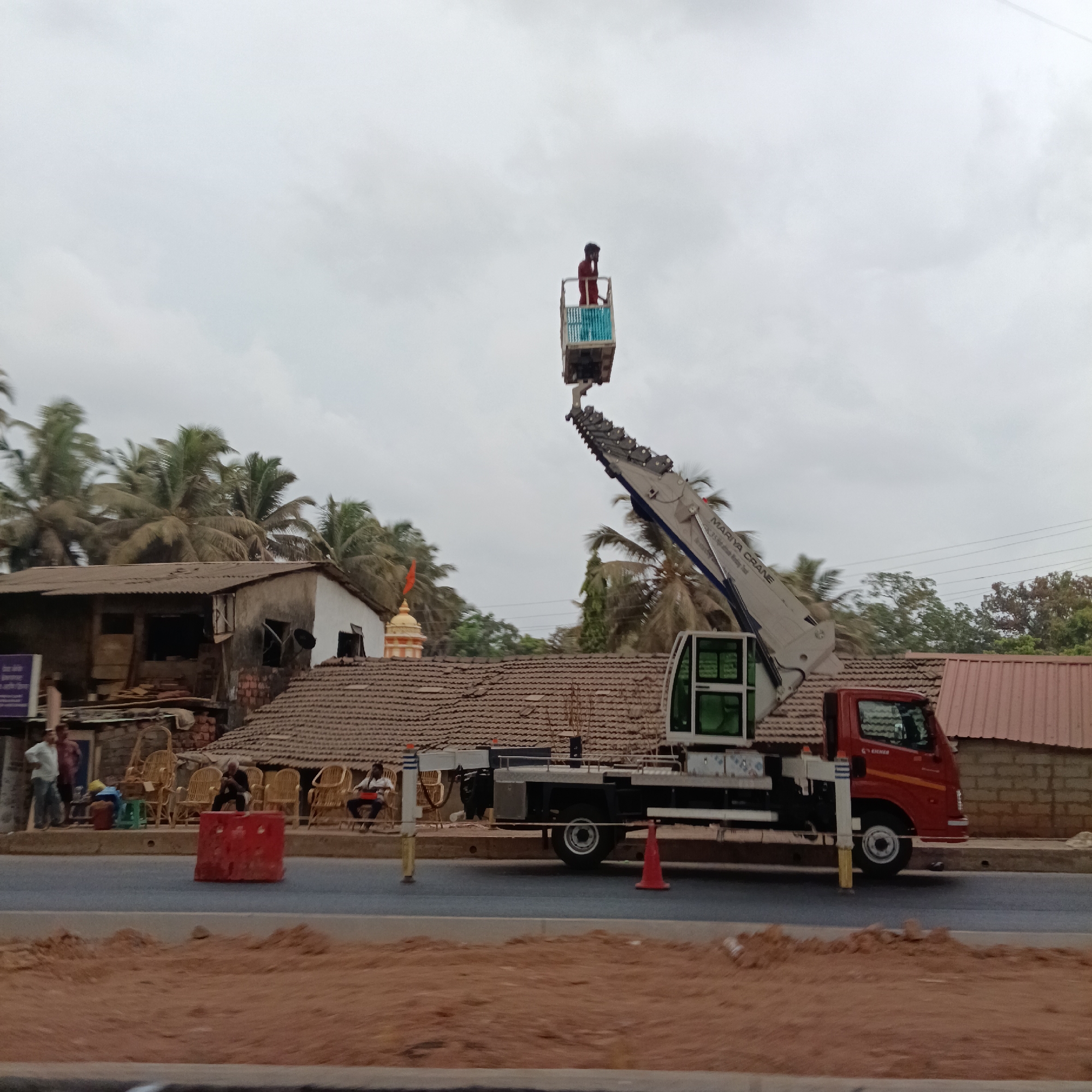 Crane operator works from elevated bucket in Sangolda