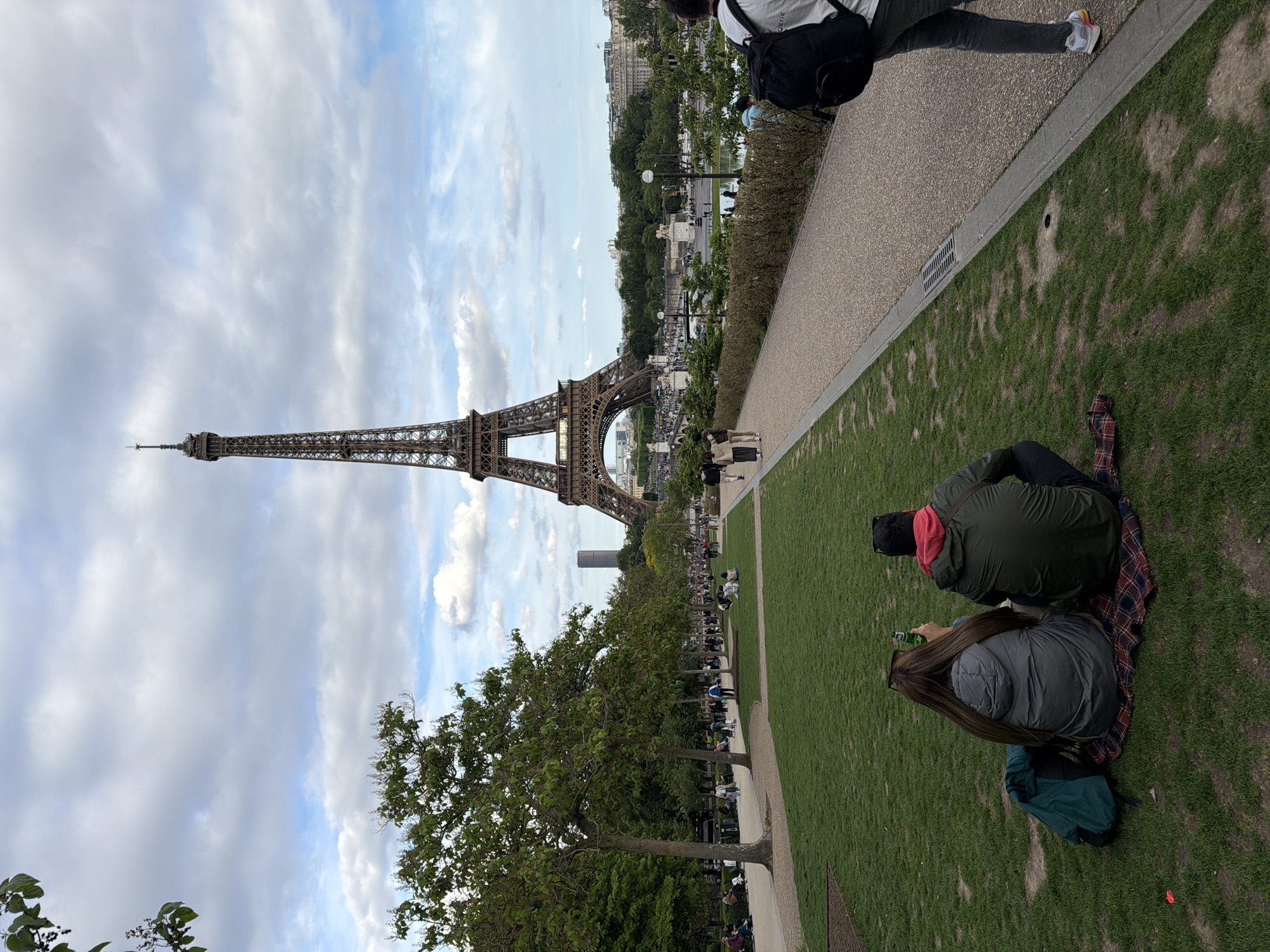 Tourist photographs Eiffel Tower from multiple angles at Trocadéro