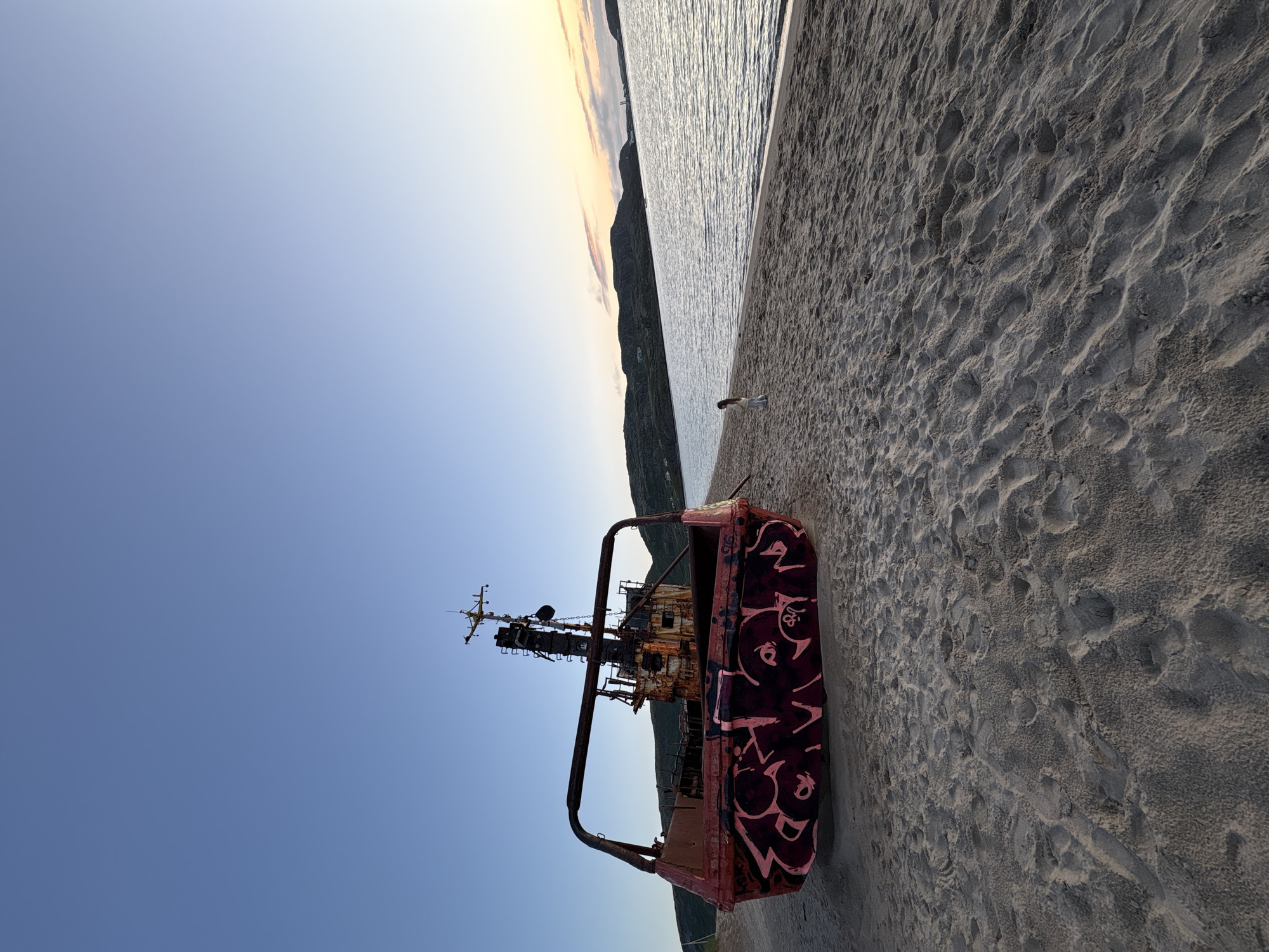 Abandoned shipwreck and quiet beachside moment in Teriberka