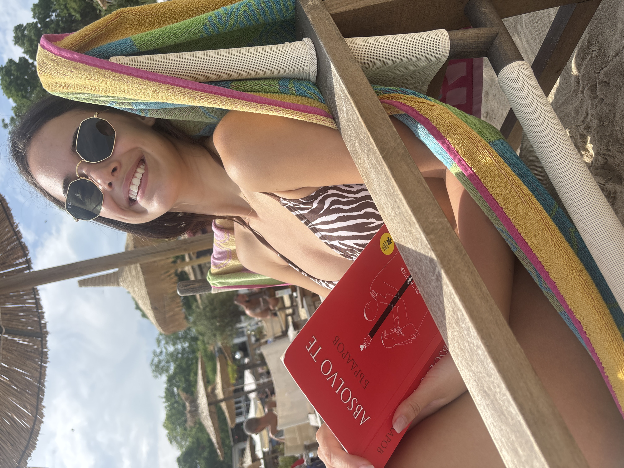 Beachgoer reads Bulgarian book while relaxing in Varna