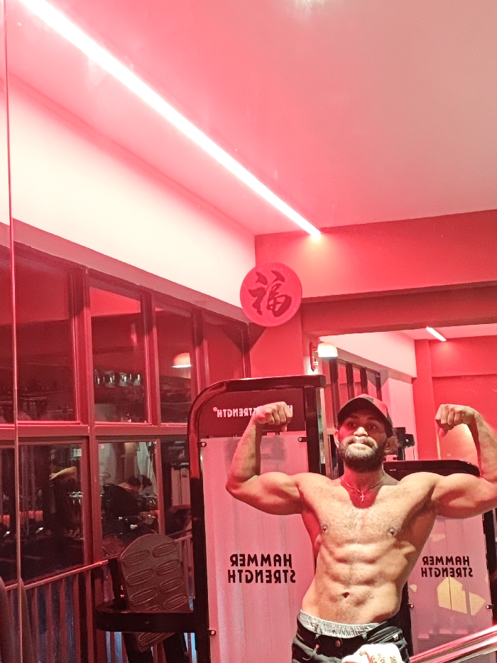 Man Takes Mirror Selfies in Red-Lit Chongqing Gym