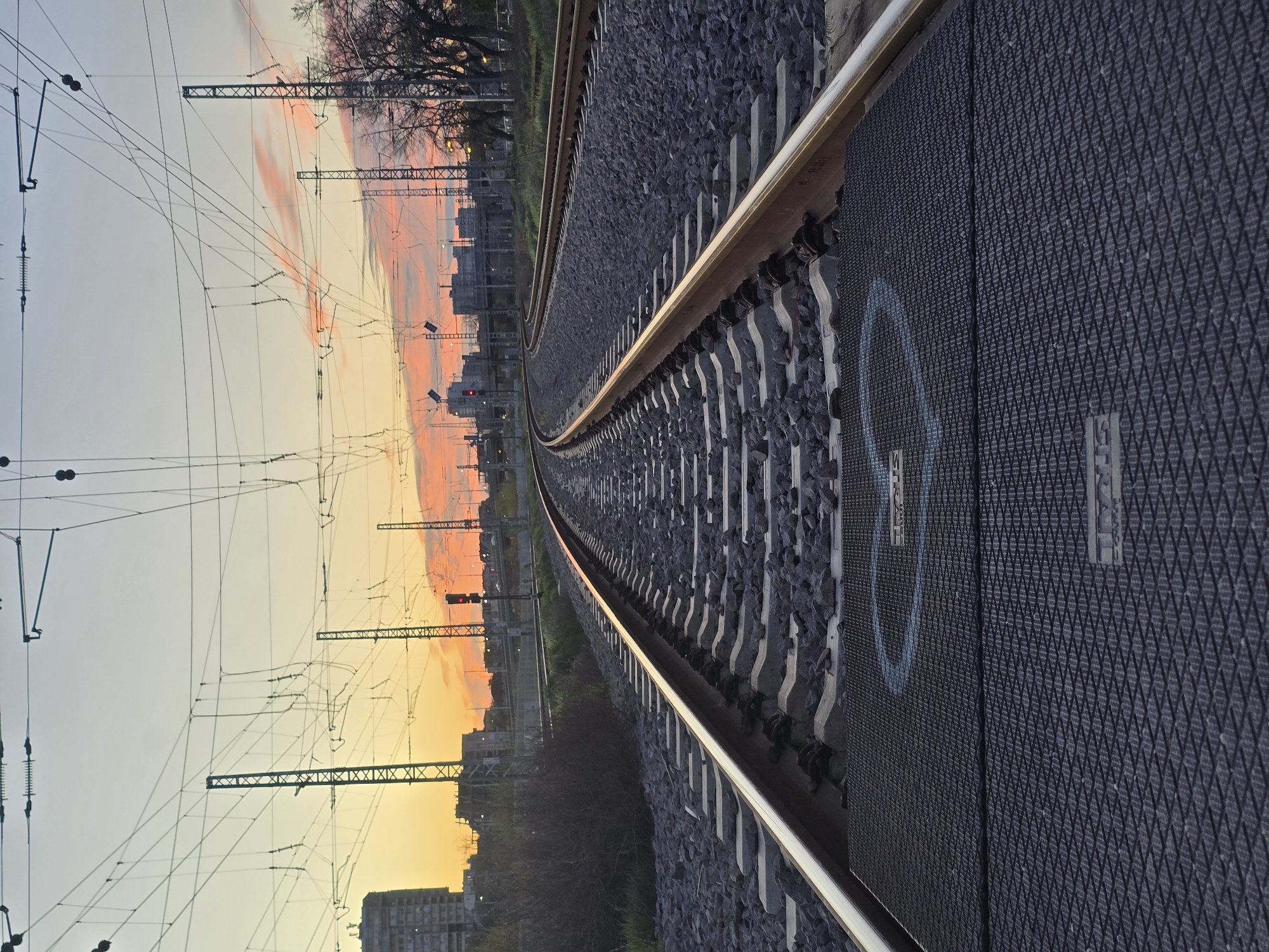 Train approaches through urban Plovdiv at dawn