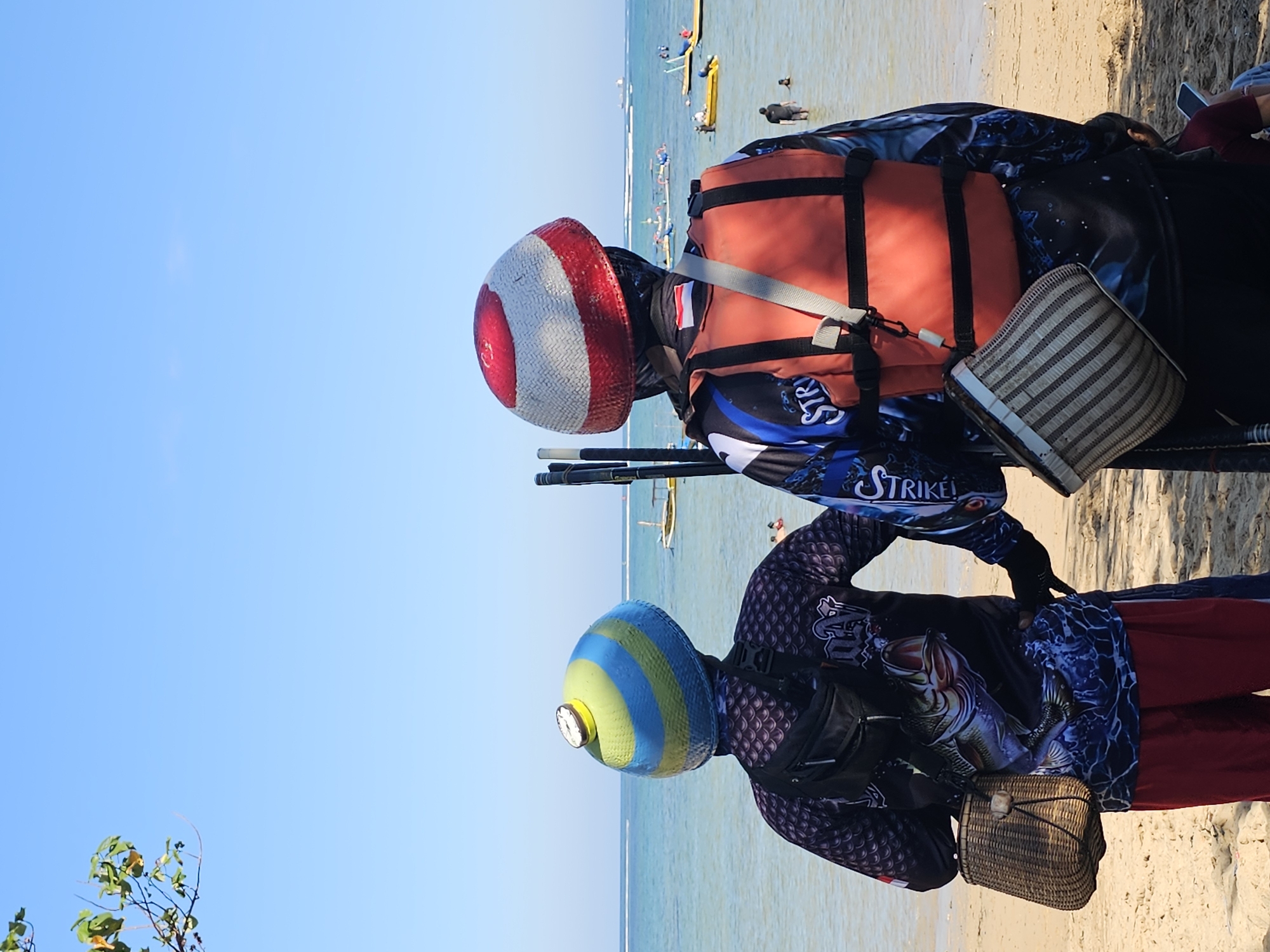 Busy Bali coastline morning: beach life, fishing, and passing boats