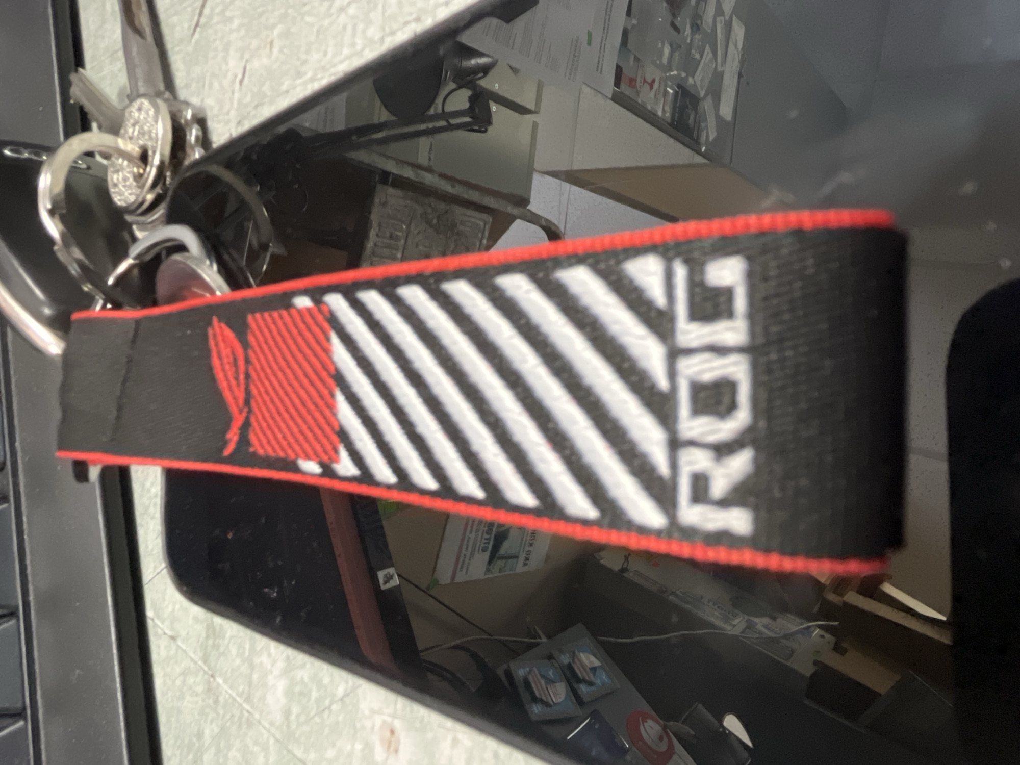 ROG-branded keychain with striped pattern observed in close-up