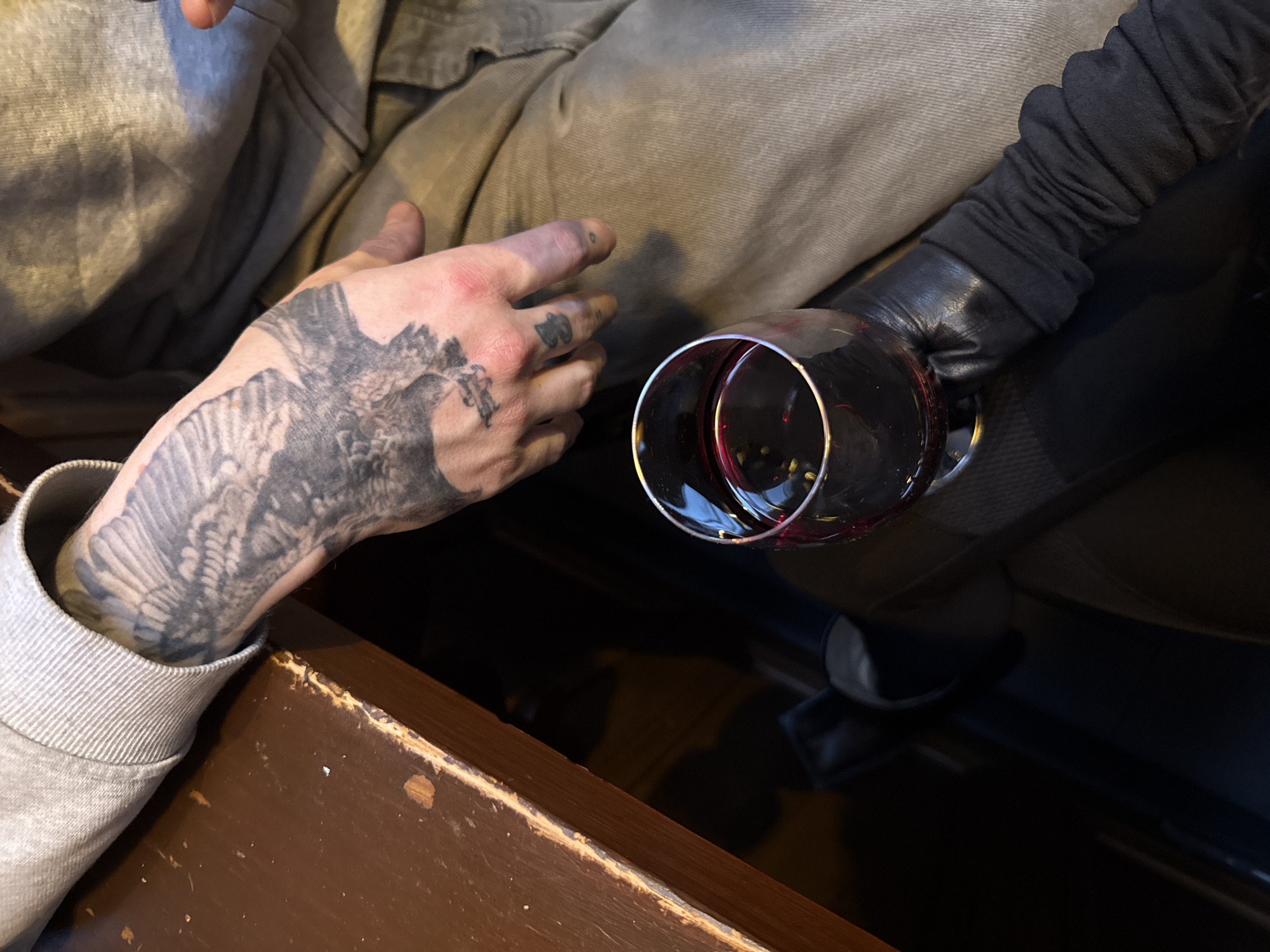 Two people meet at Edinburgh venue, bird tattoo visible