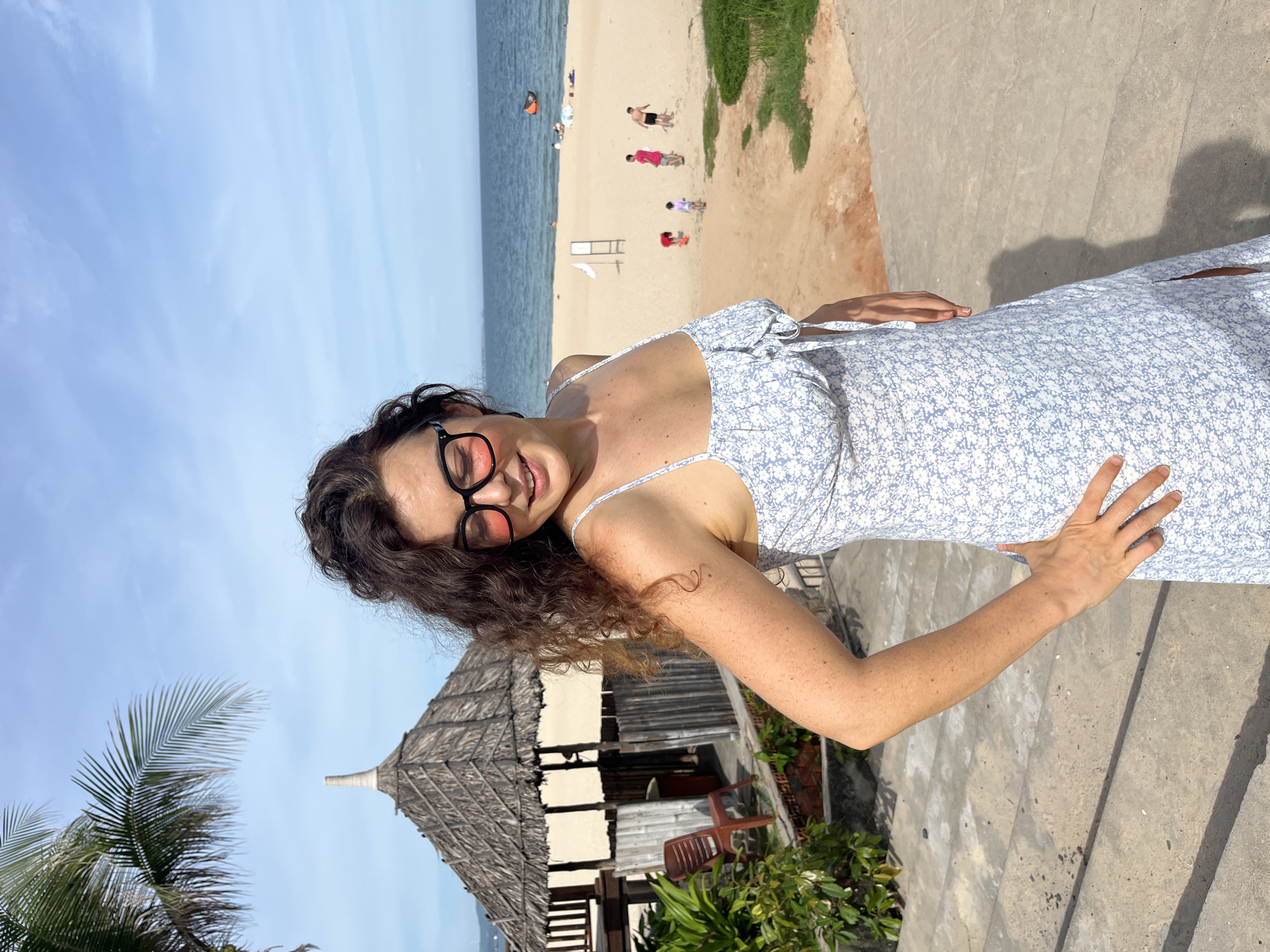 Posing through Mũi Né's coastal garden installations, blue dress throughout