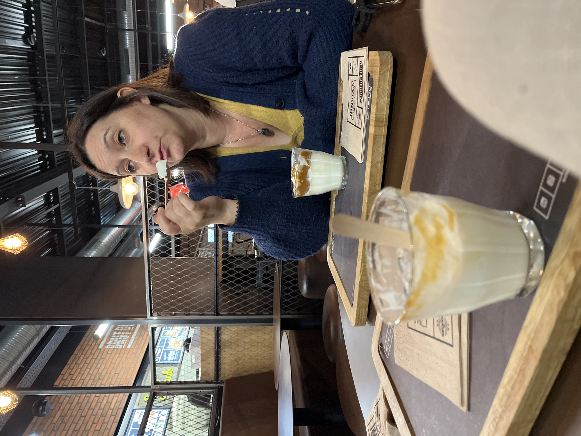 Woman enjoys dessert in Andrézieux-Bouthéon dining moment