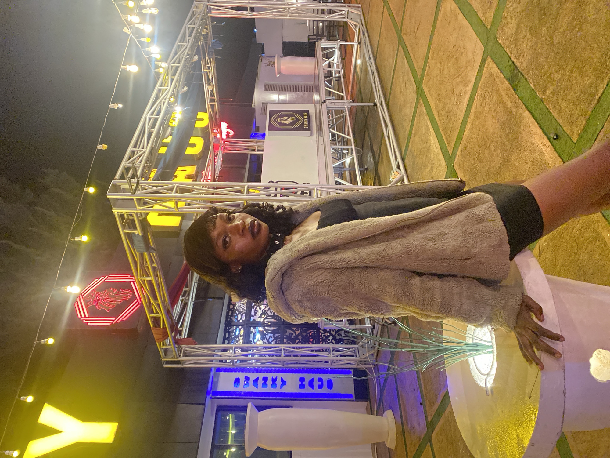 Dressed up for a night out at an outdoor venue in Nigeria