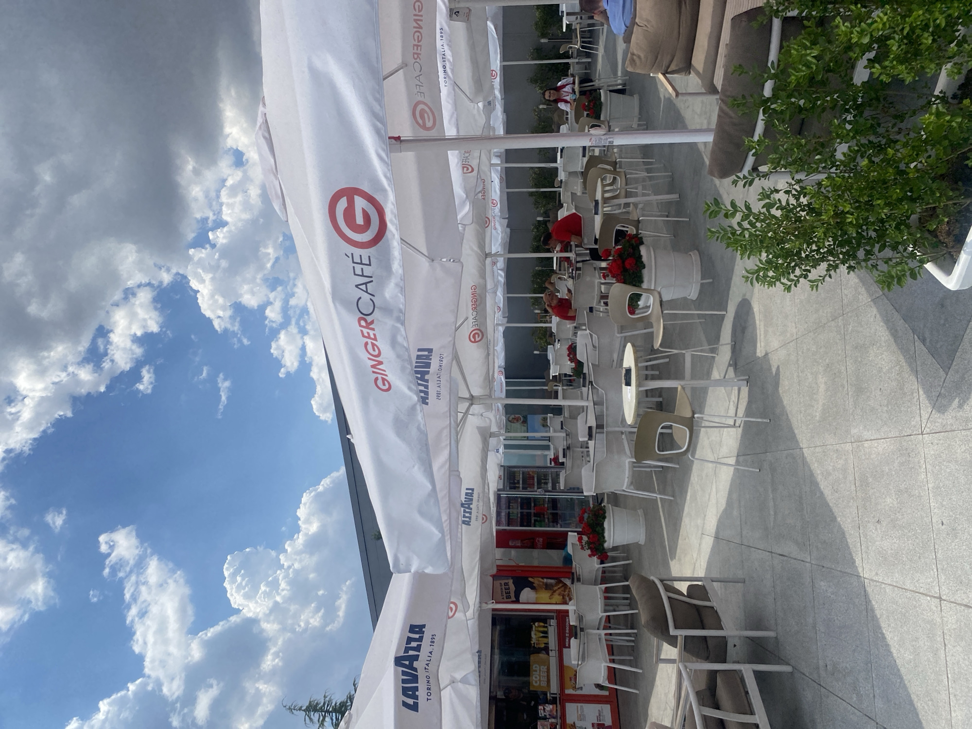 Around Burgas Airport: terminal, parked buses, and a GingerCafé
