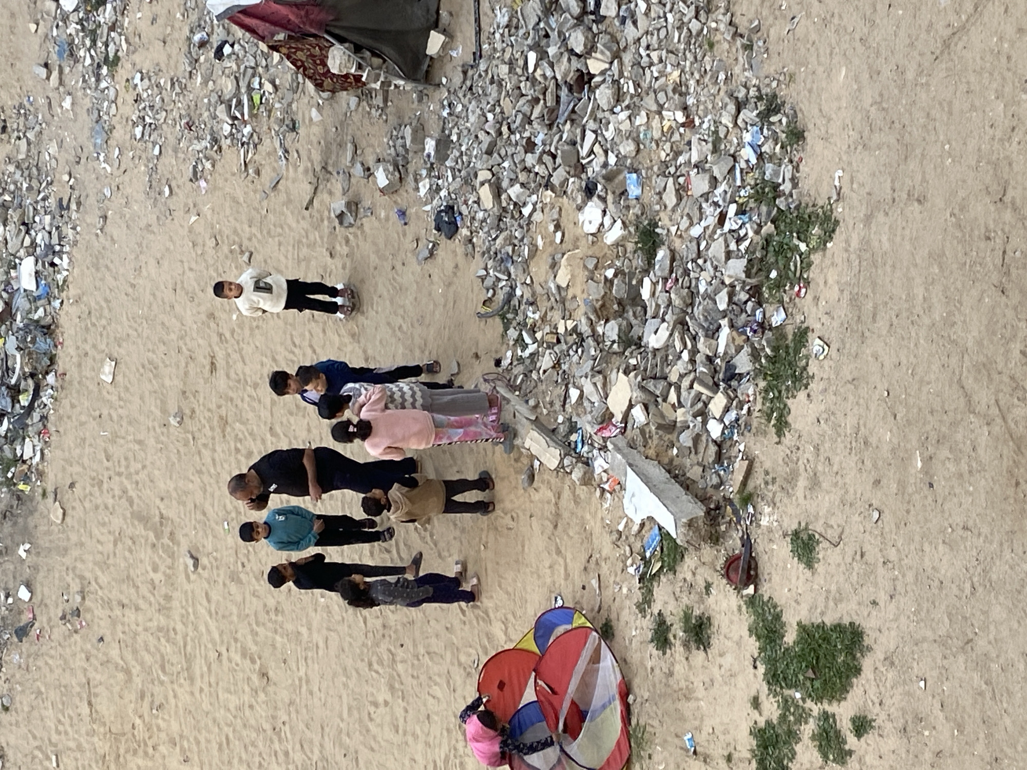 Children gather in debris-filled areas of Khan Yunis