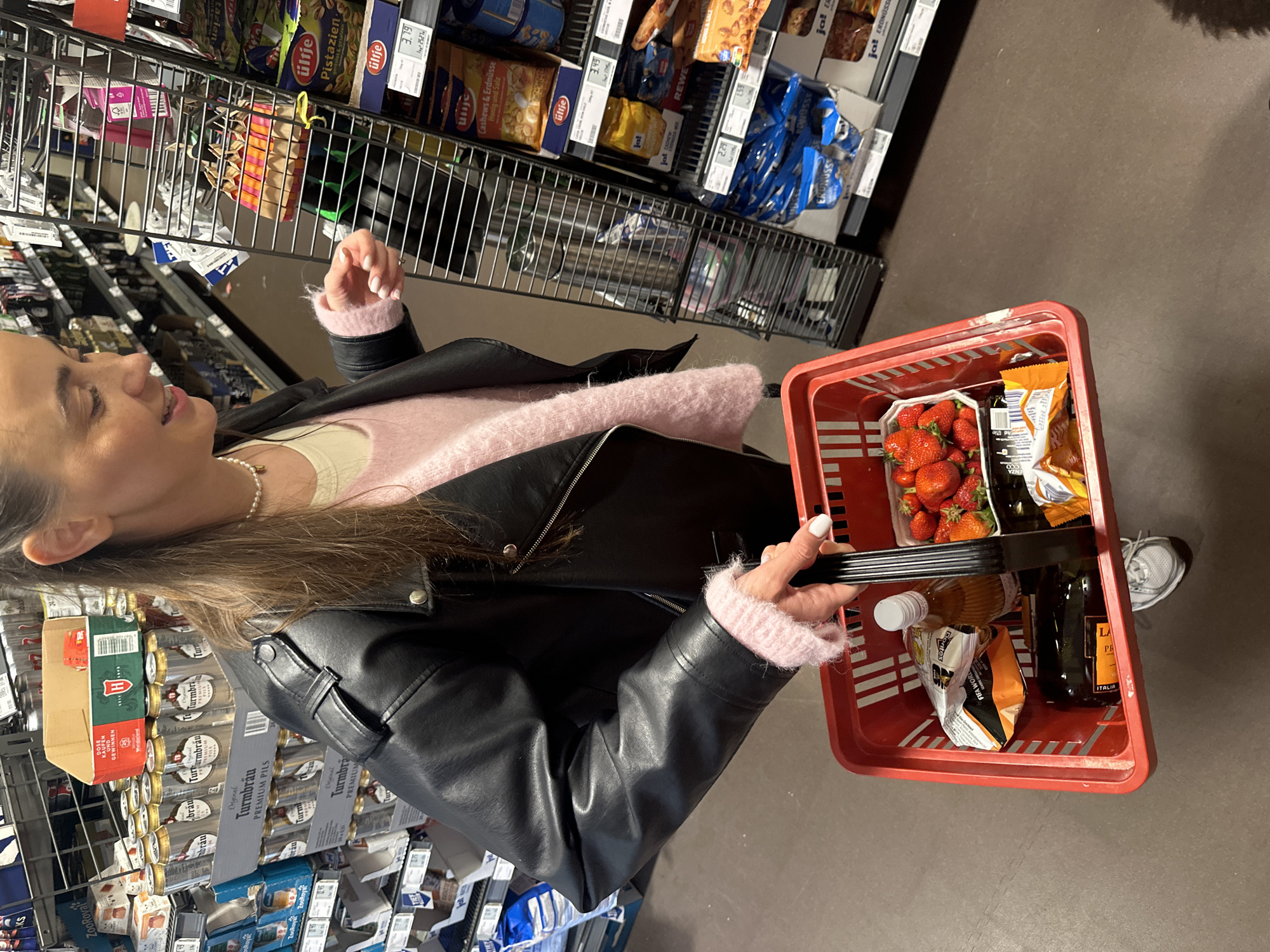 Woman shops for groceries at REWE store in Kiel