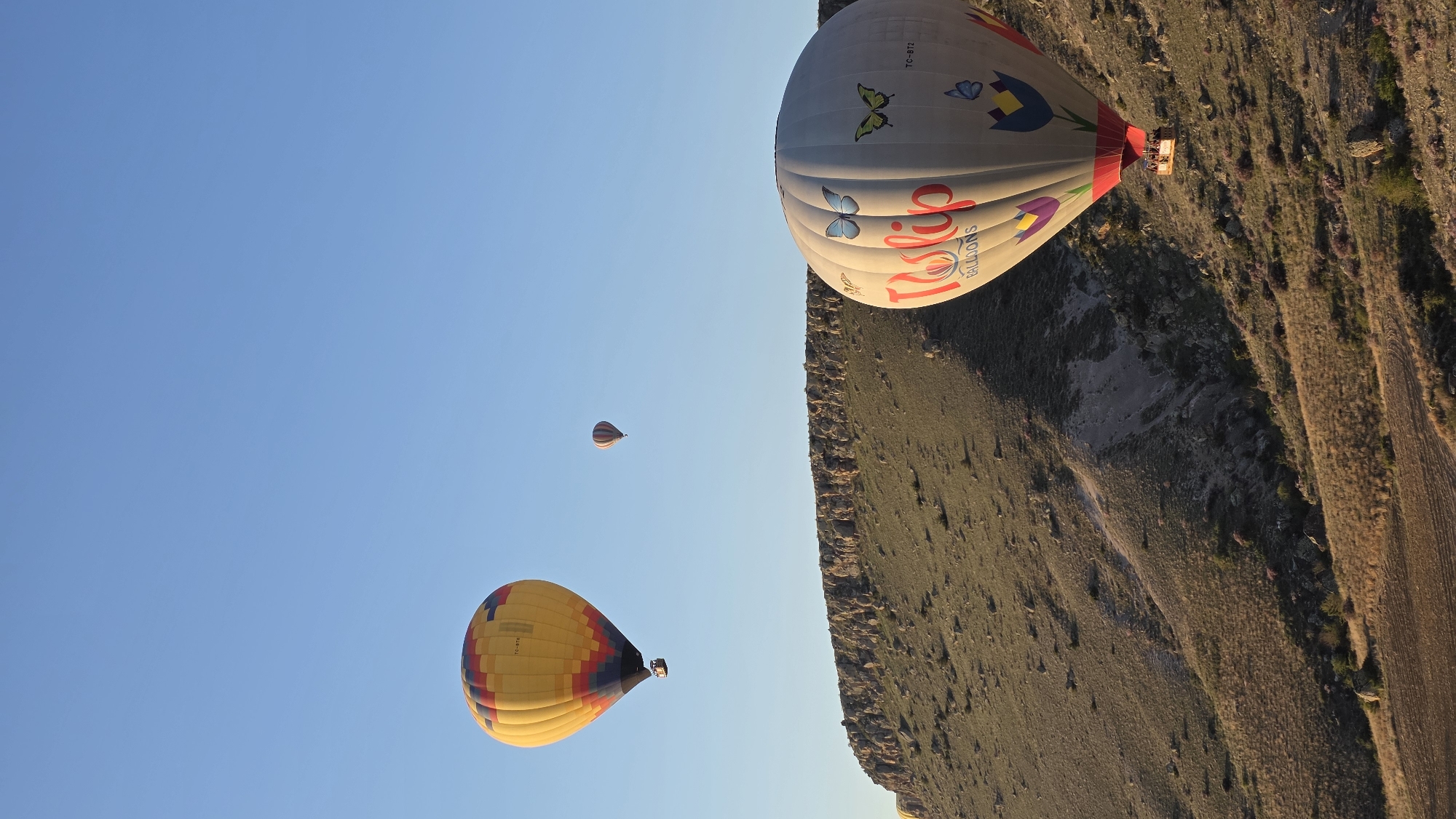 Hot air balloons soar over Ürgüp landscape at dawn