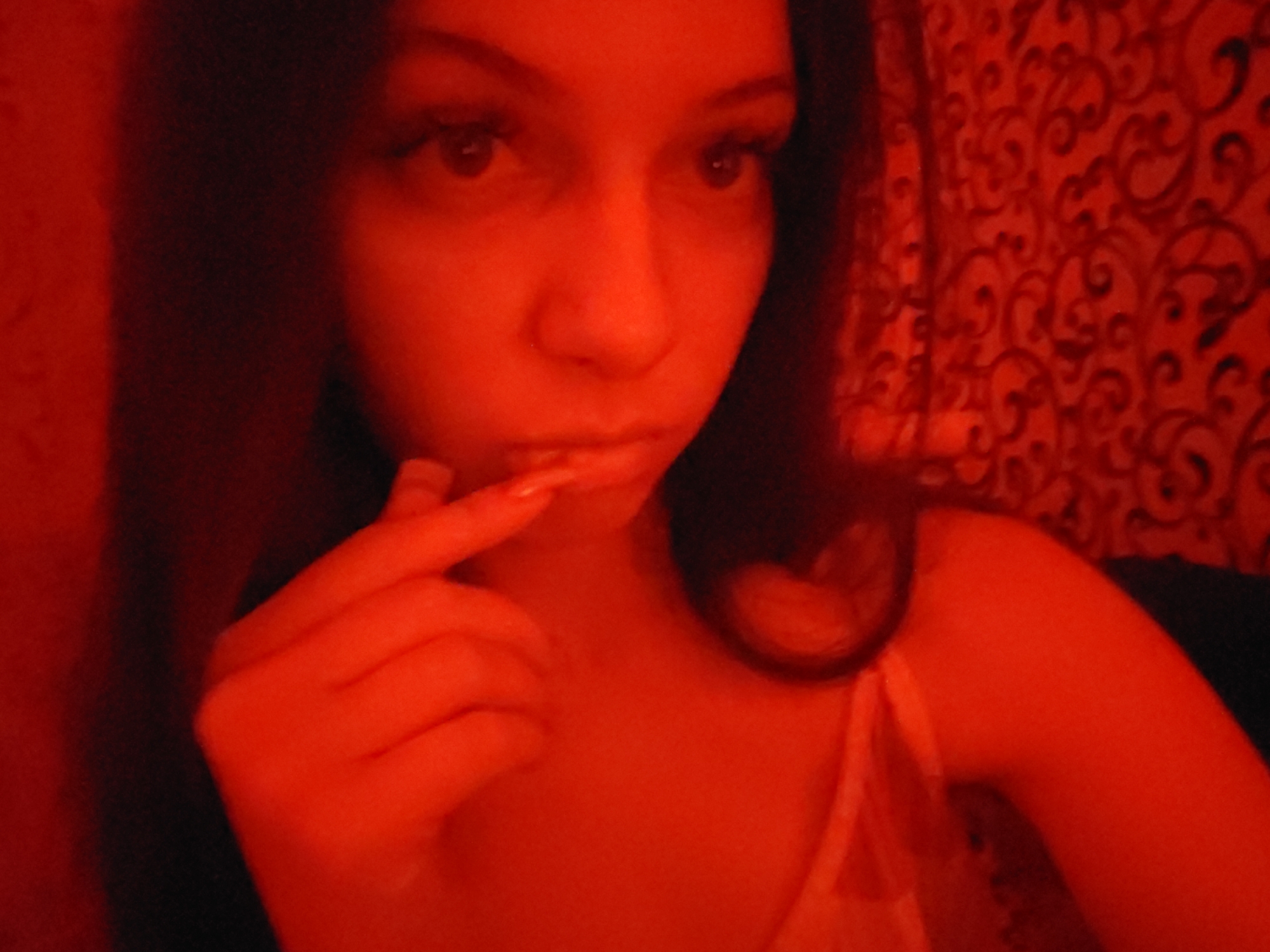 Red-lit room in Chystiakove, close-up self-portraits at night.