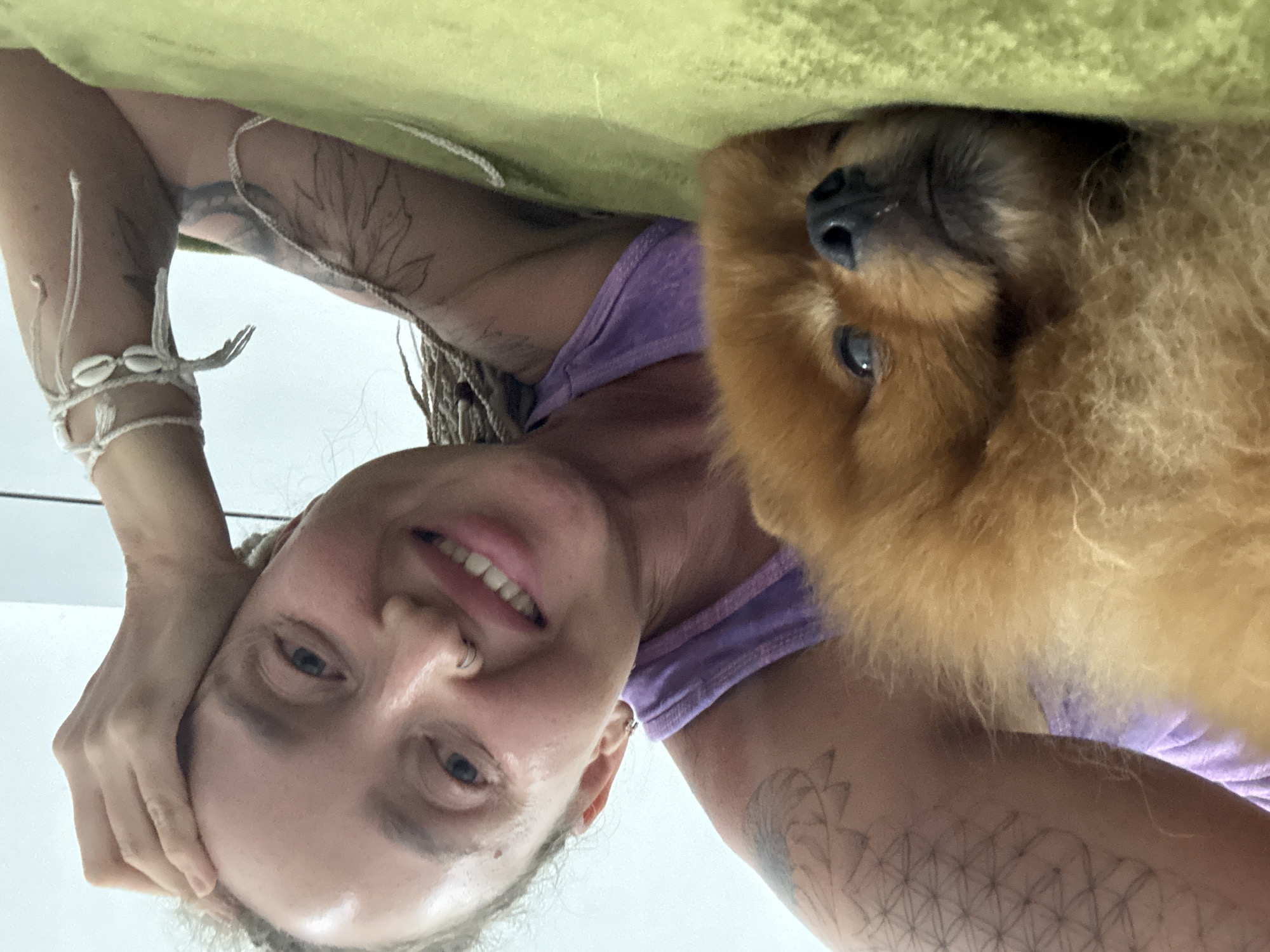 Lazy afternoon on a green blanket with a sleeping Pomeranian in Nha Trang