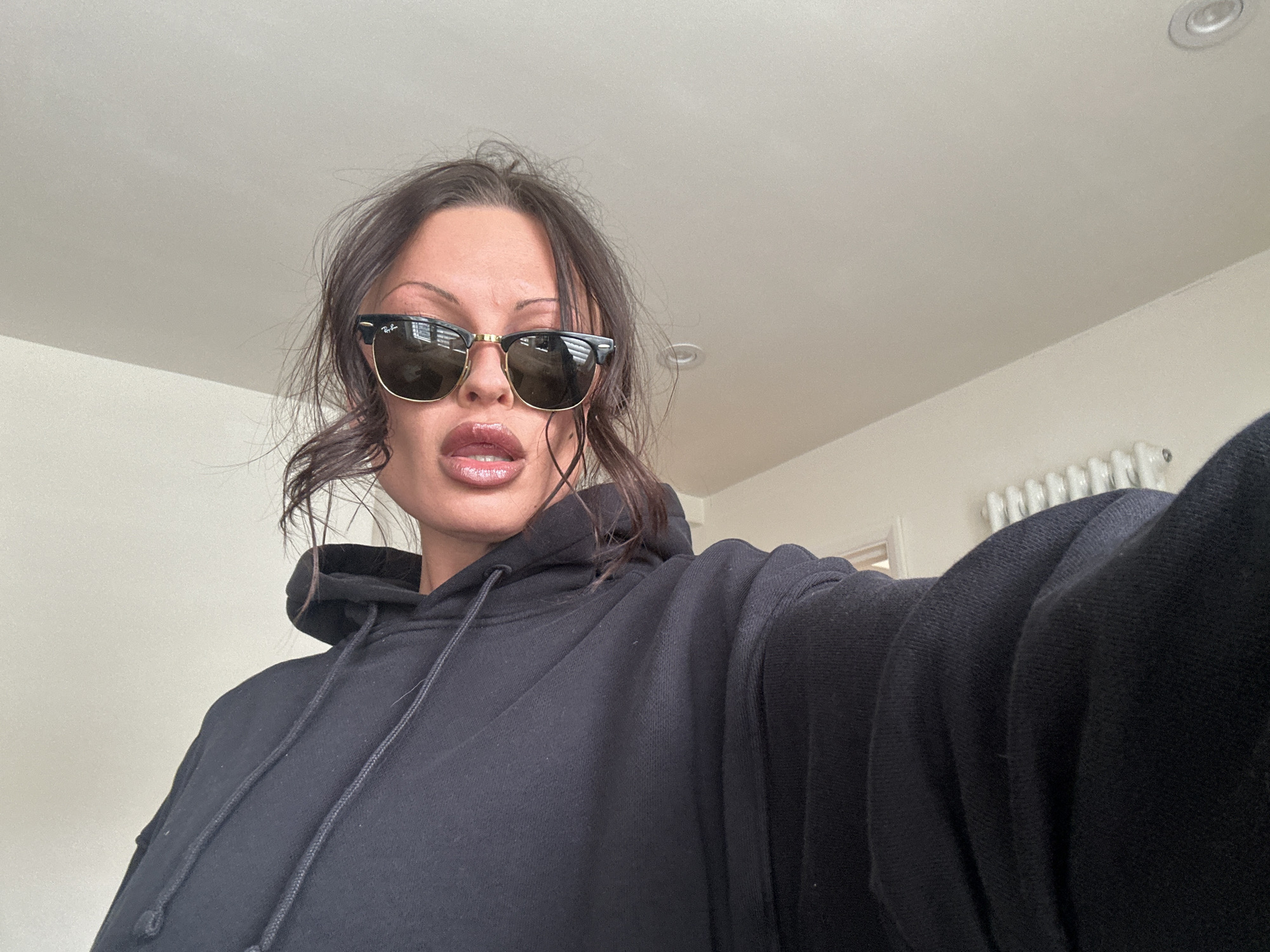 Woman in sunglasses, hoodie spotted indoors in Tunbridge Wells