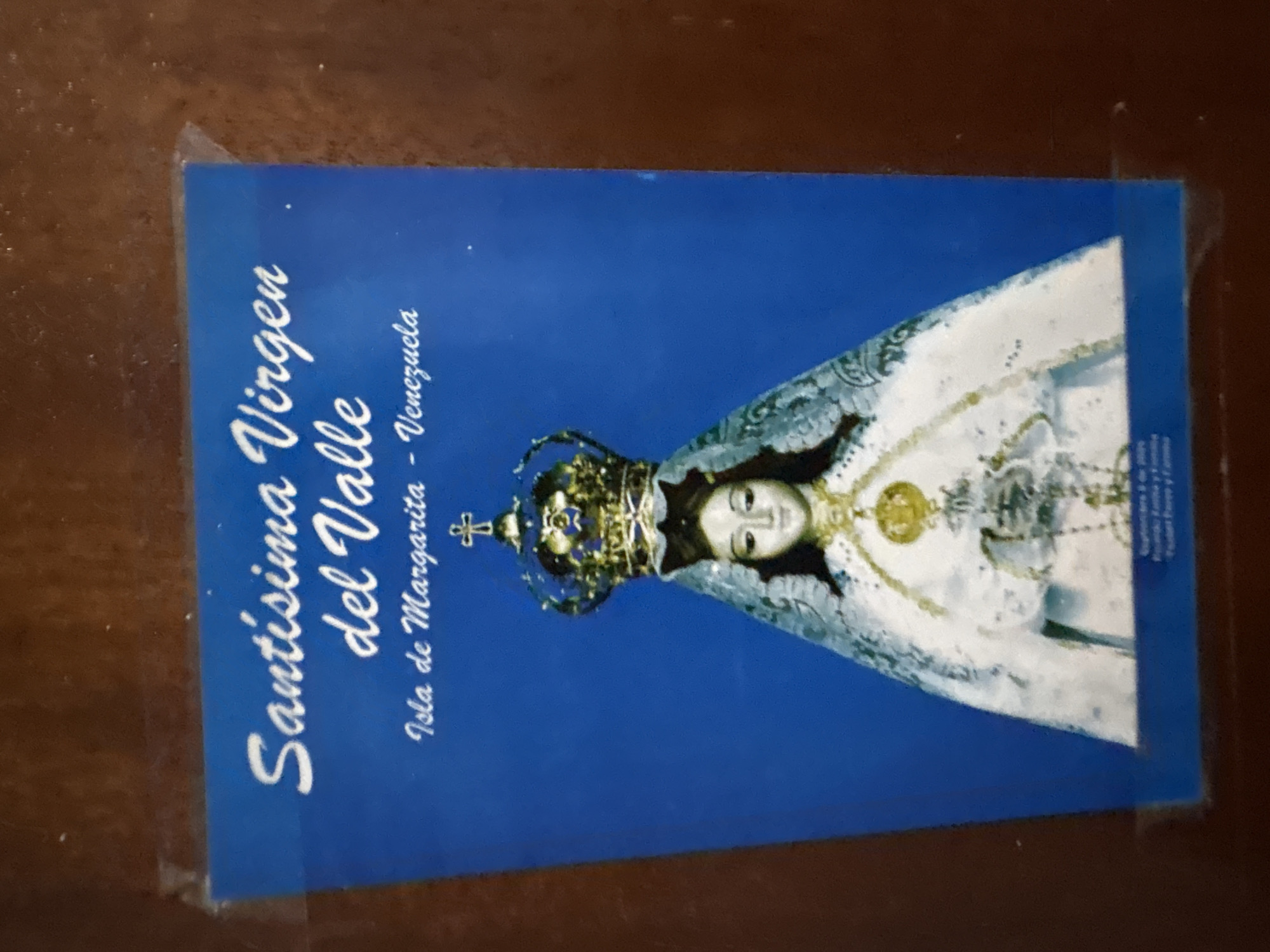 Assorted personal items — religious prints, a compass, posters — photographed up close
