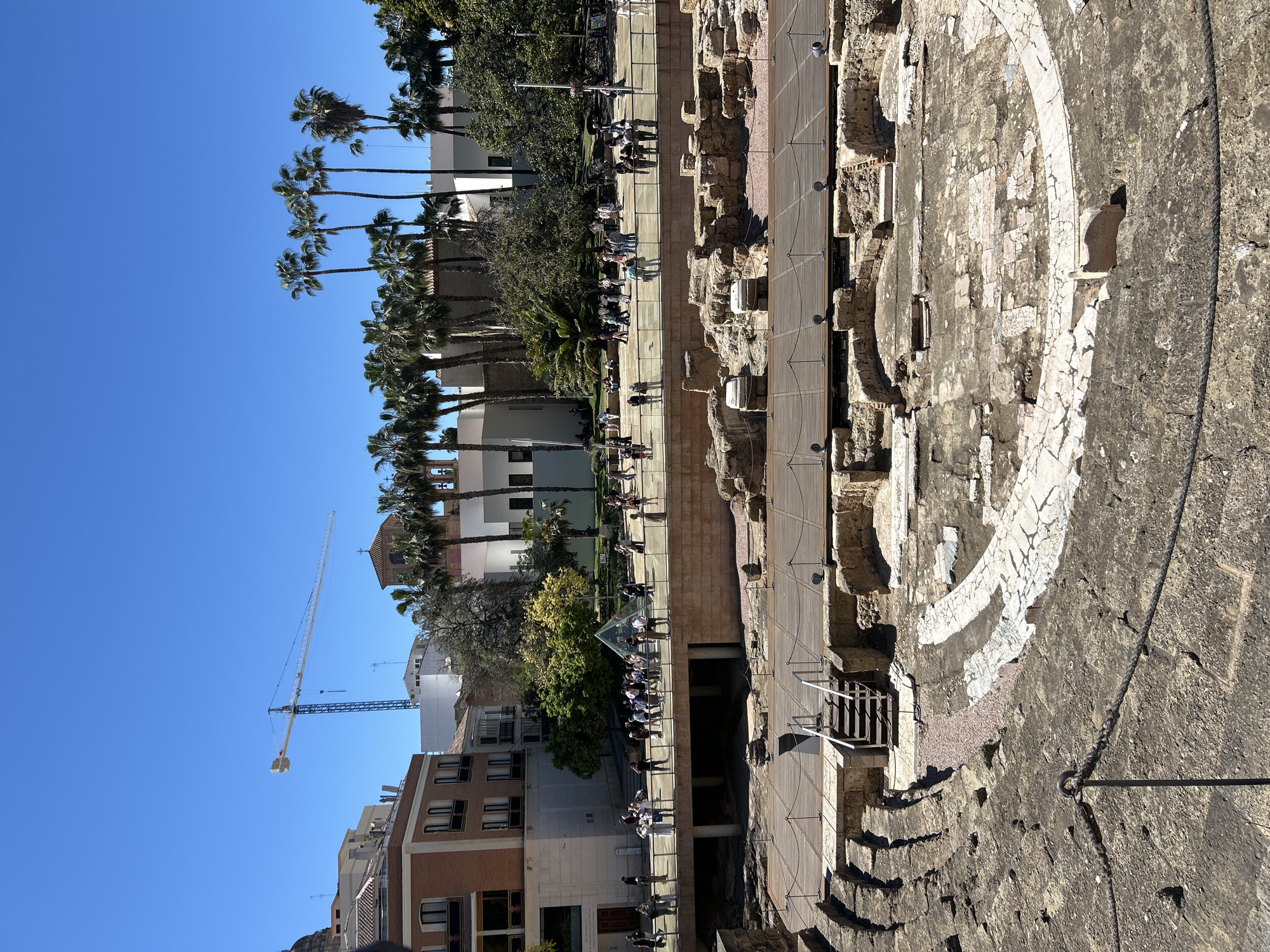 Park scene captured in Málaga showing people on benches