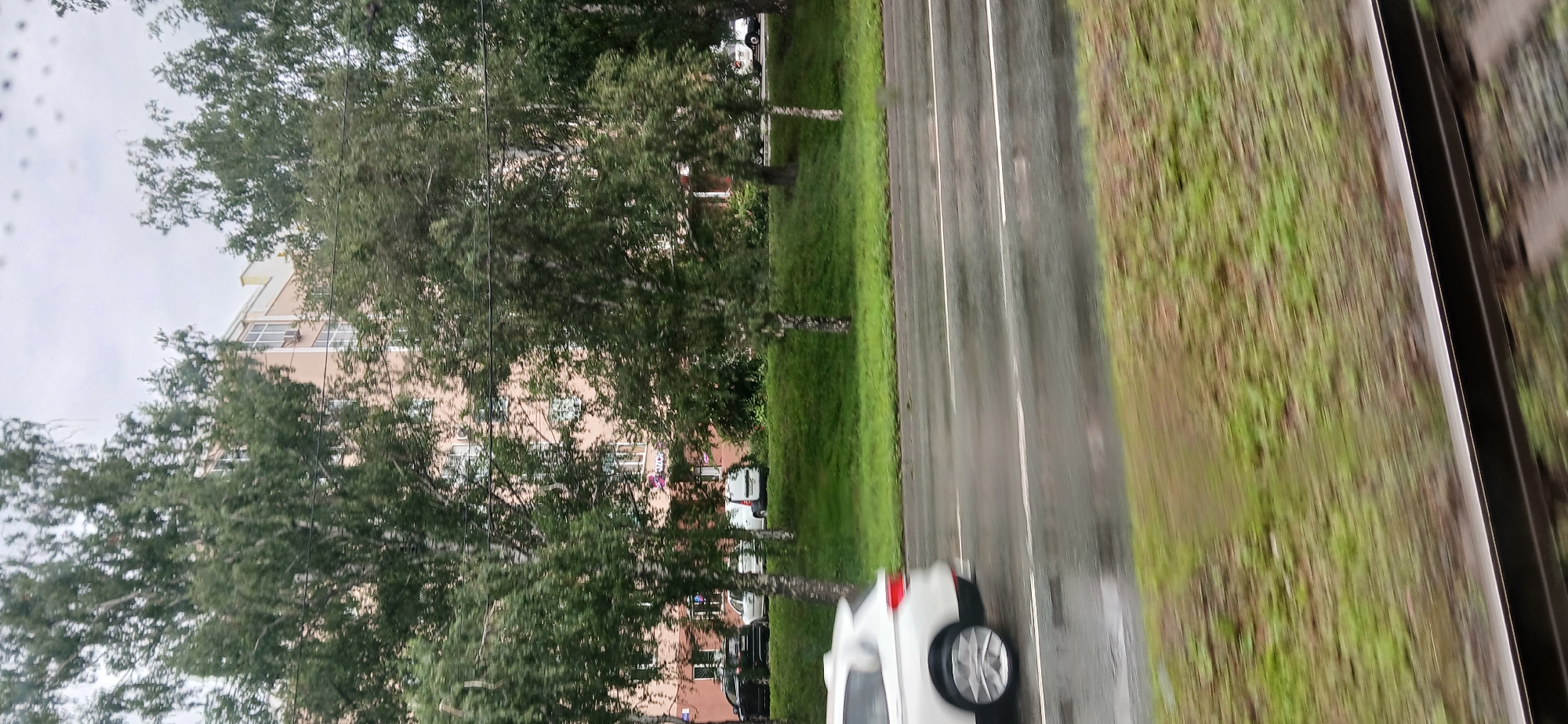Rainy morning transit through Chelyabinsk streets and rail crossings
