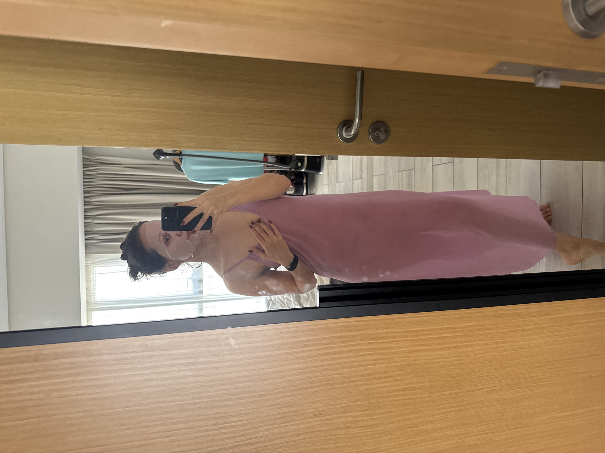 Woman documents skincare routine with mirror selfies in Dubai hotel