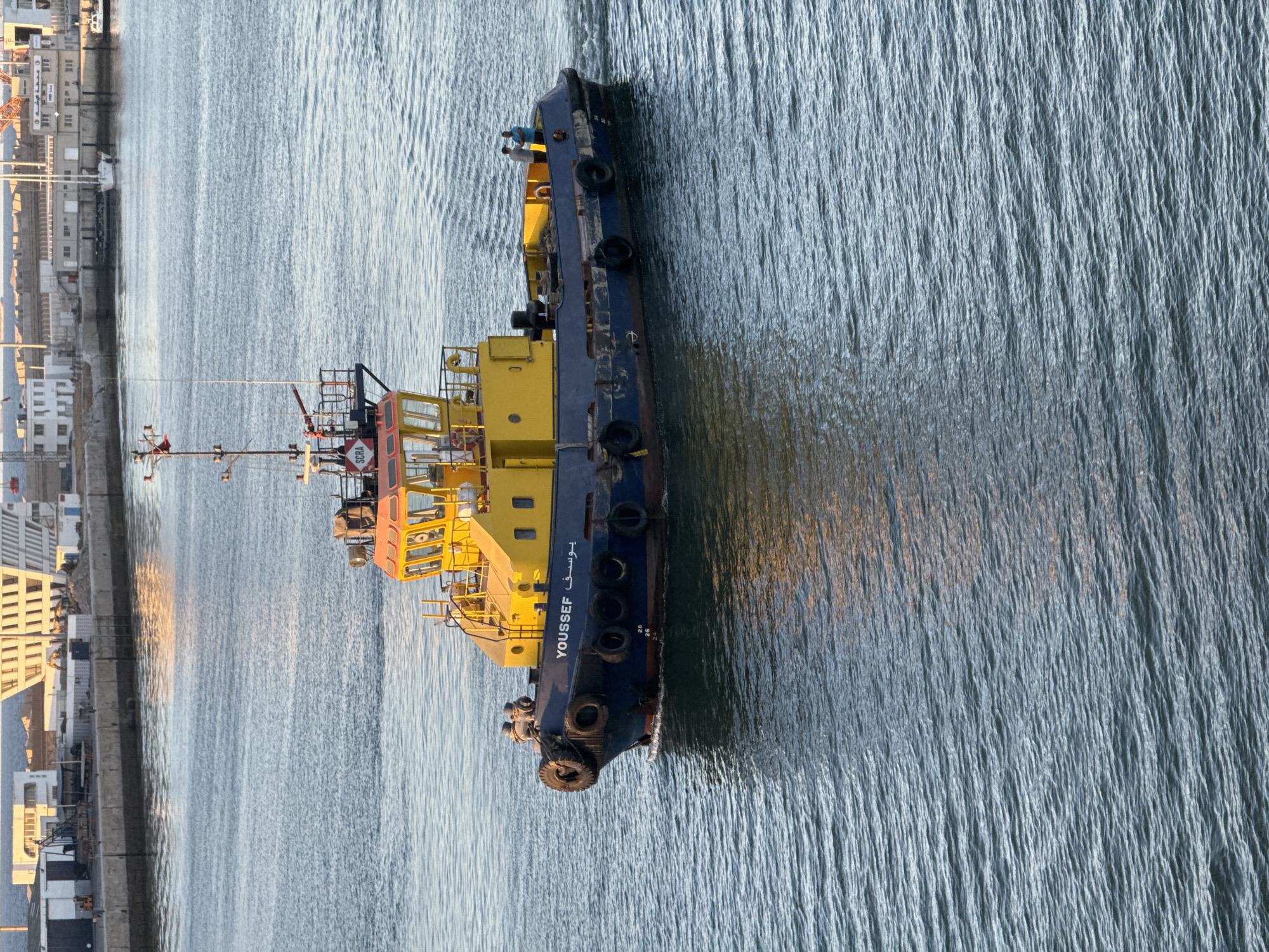 Harbor traffic in Casablanca: tugs, pilot boats, and barges at work