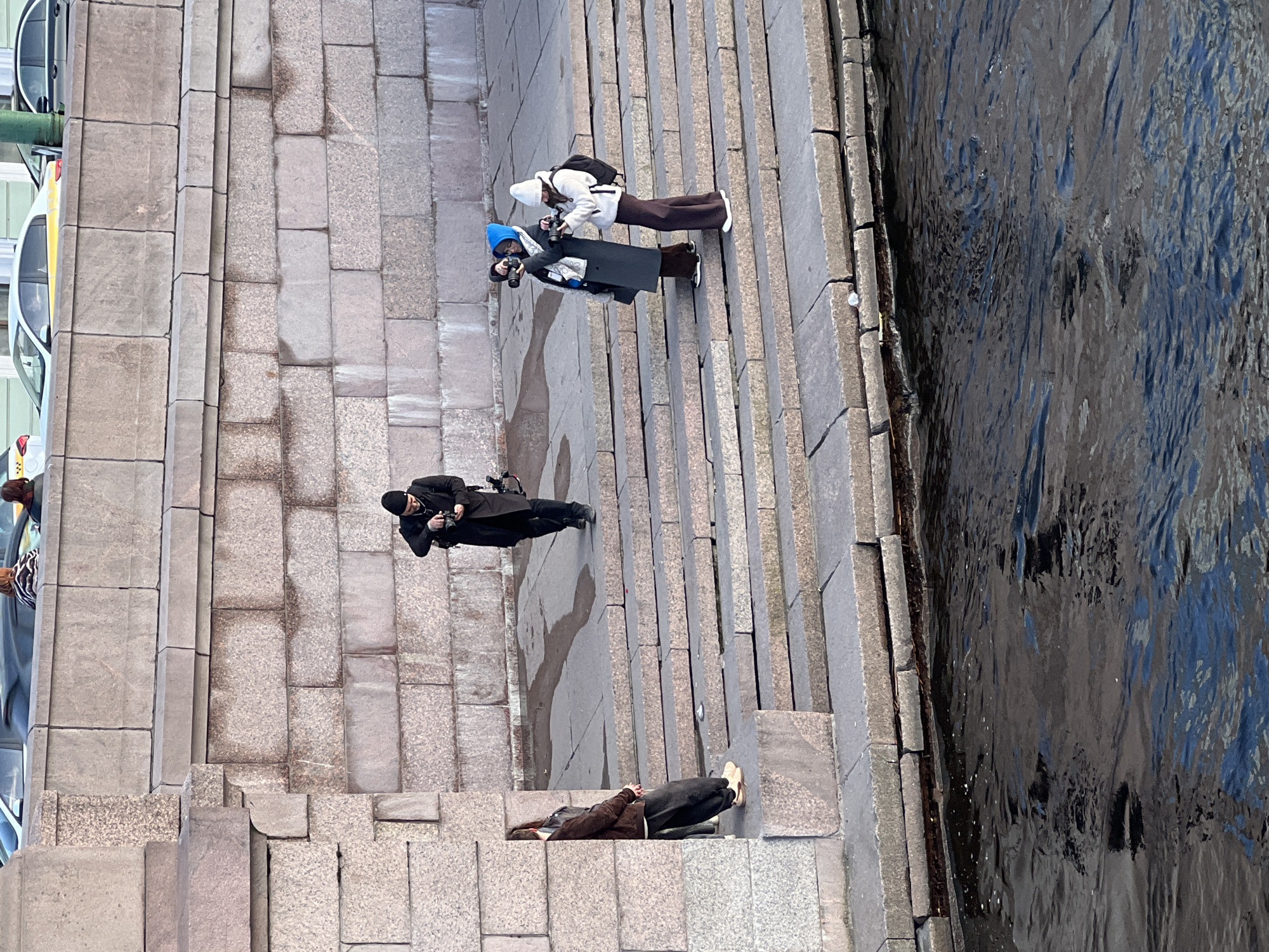 Photo session held on Neva River steps in Saint Petersburg