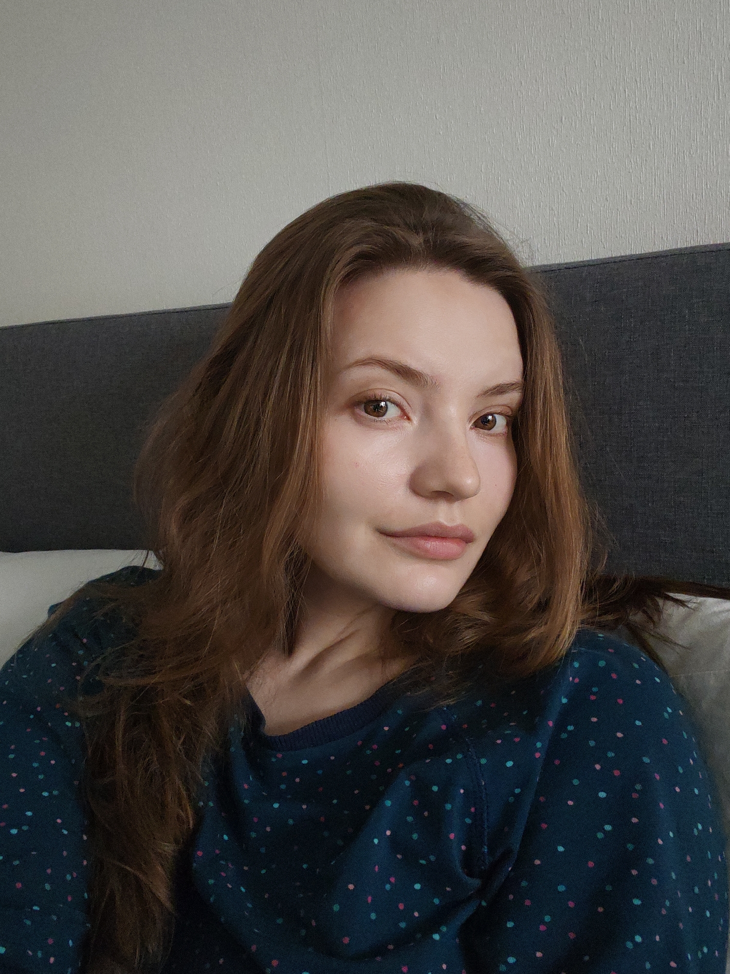 Woman photographed in close-up portraits, one from bed
