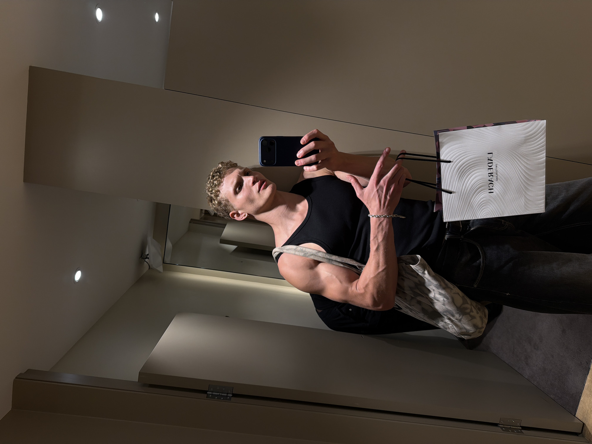 Changing room selfie with a marble-pattern bag, London