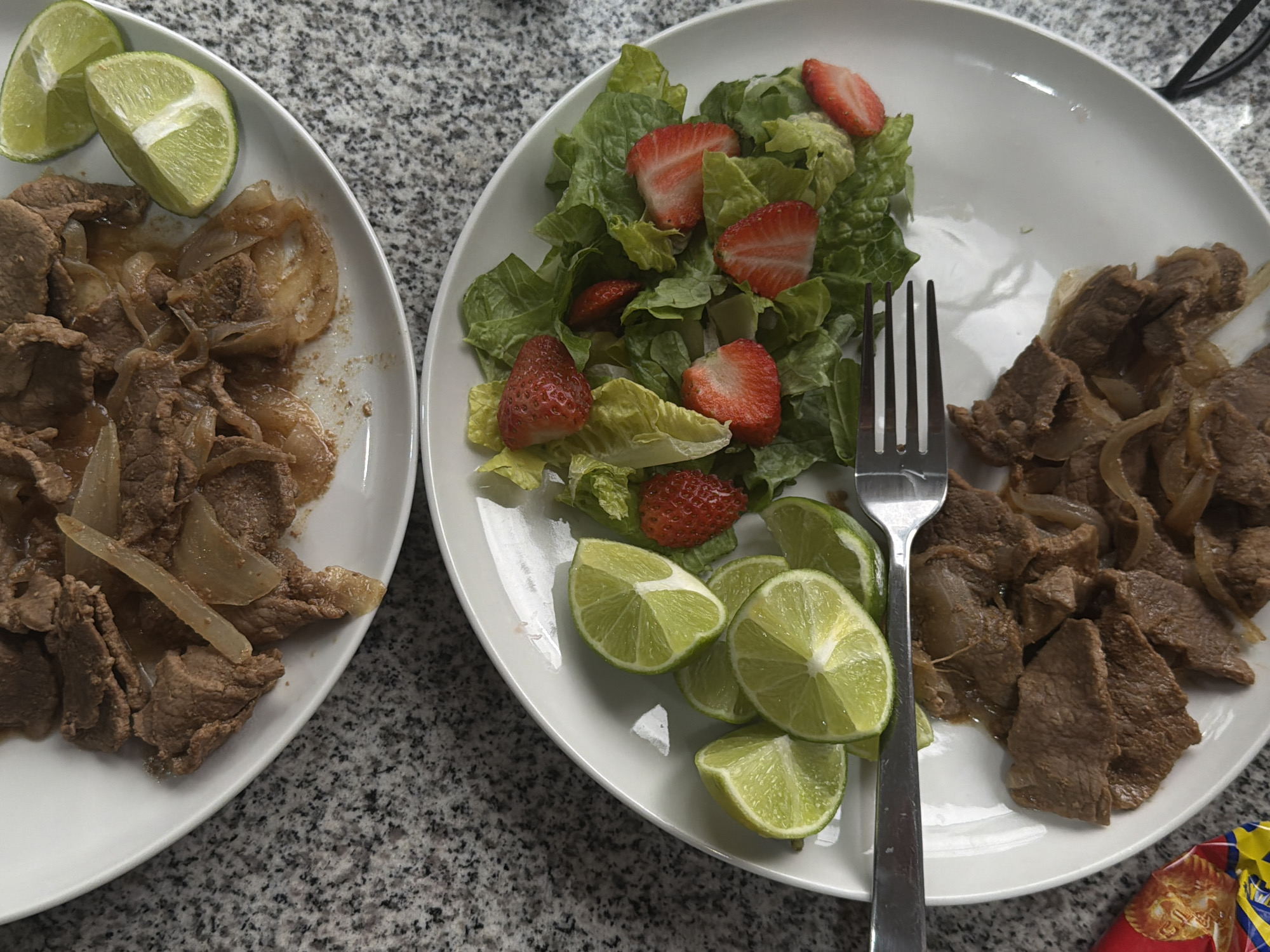 Beef and onion dinner served on gray countertop