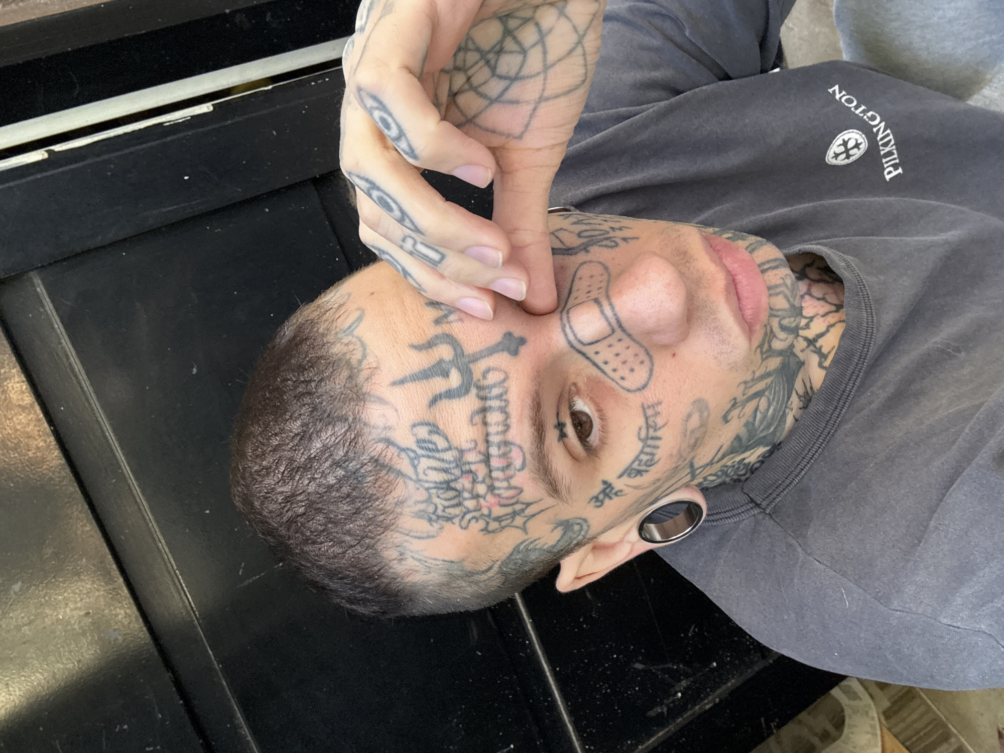 Heavily tattooed person photographed in close-up portrait in Buenos Aires