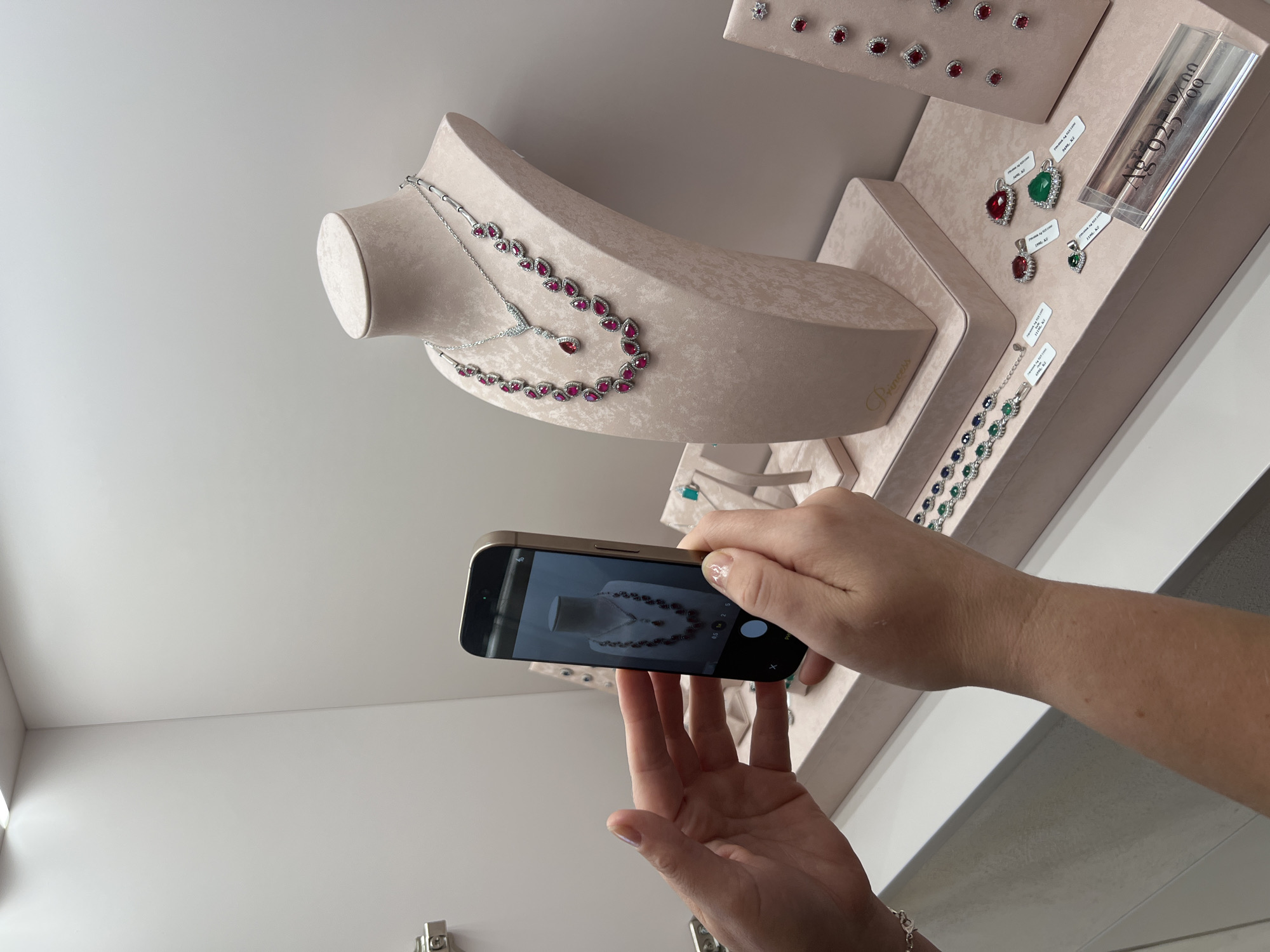 Selfies and jewelry browsing in a bright minimalist store