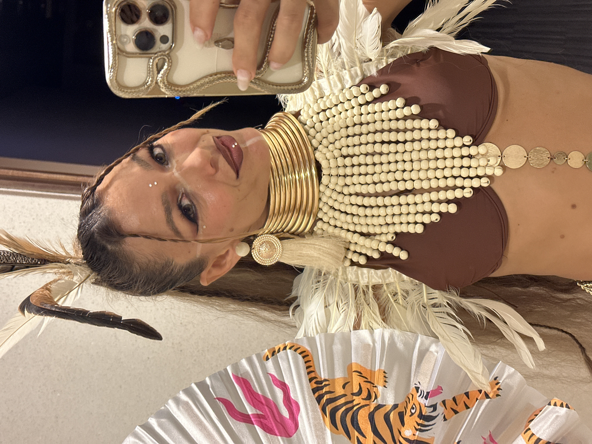 Elaborate feathered costume selfies in a Ko Samui restroom