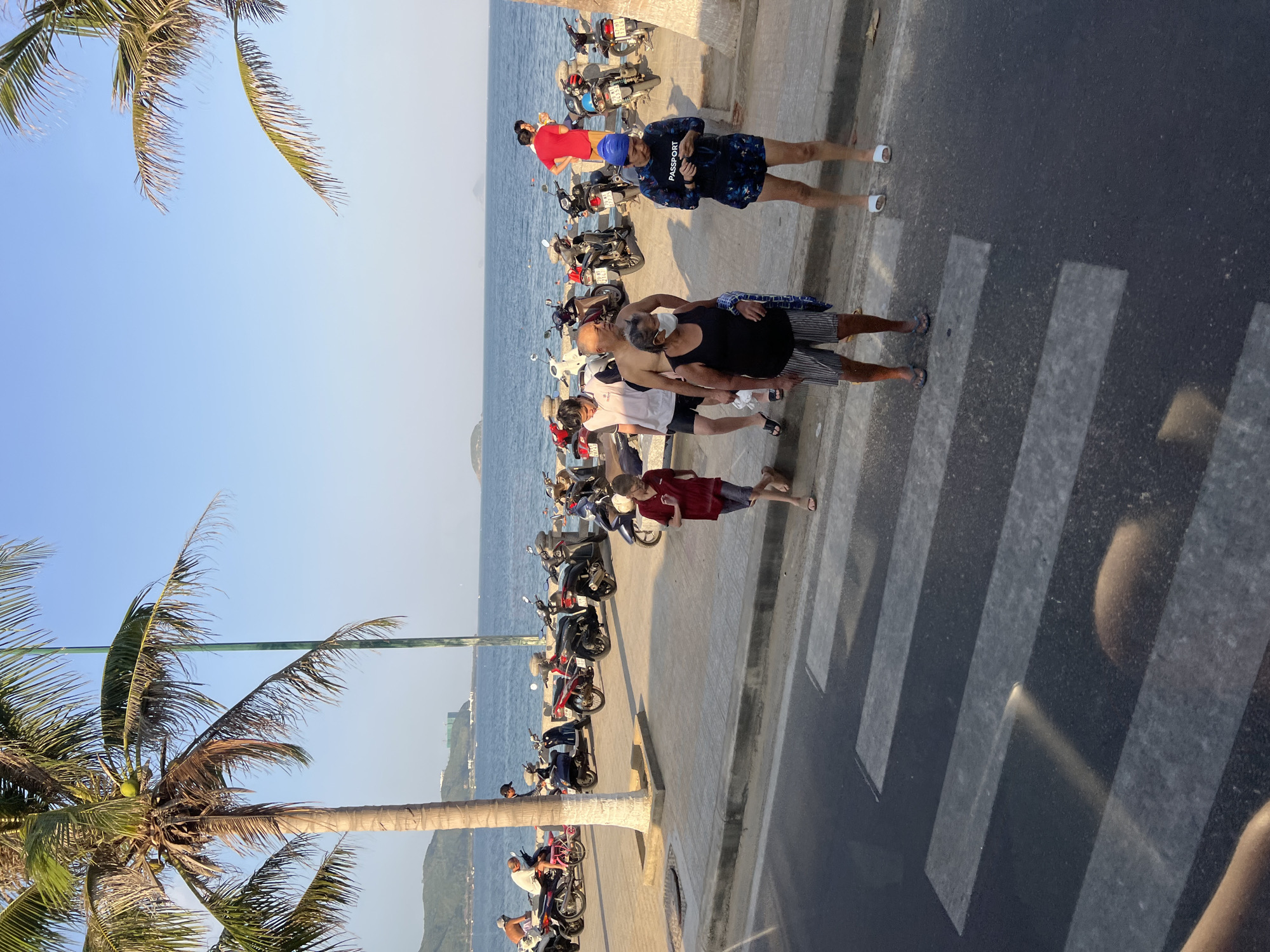 Morning scooter traffic flows along Nha Trang's beachfront promenade