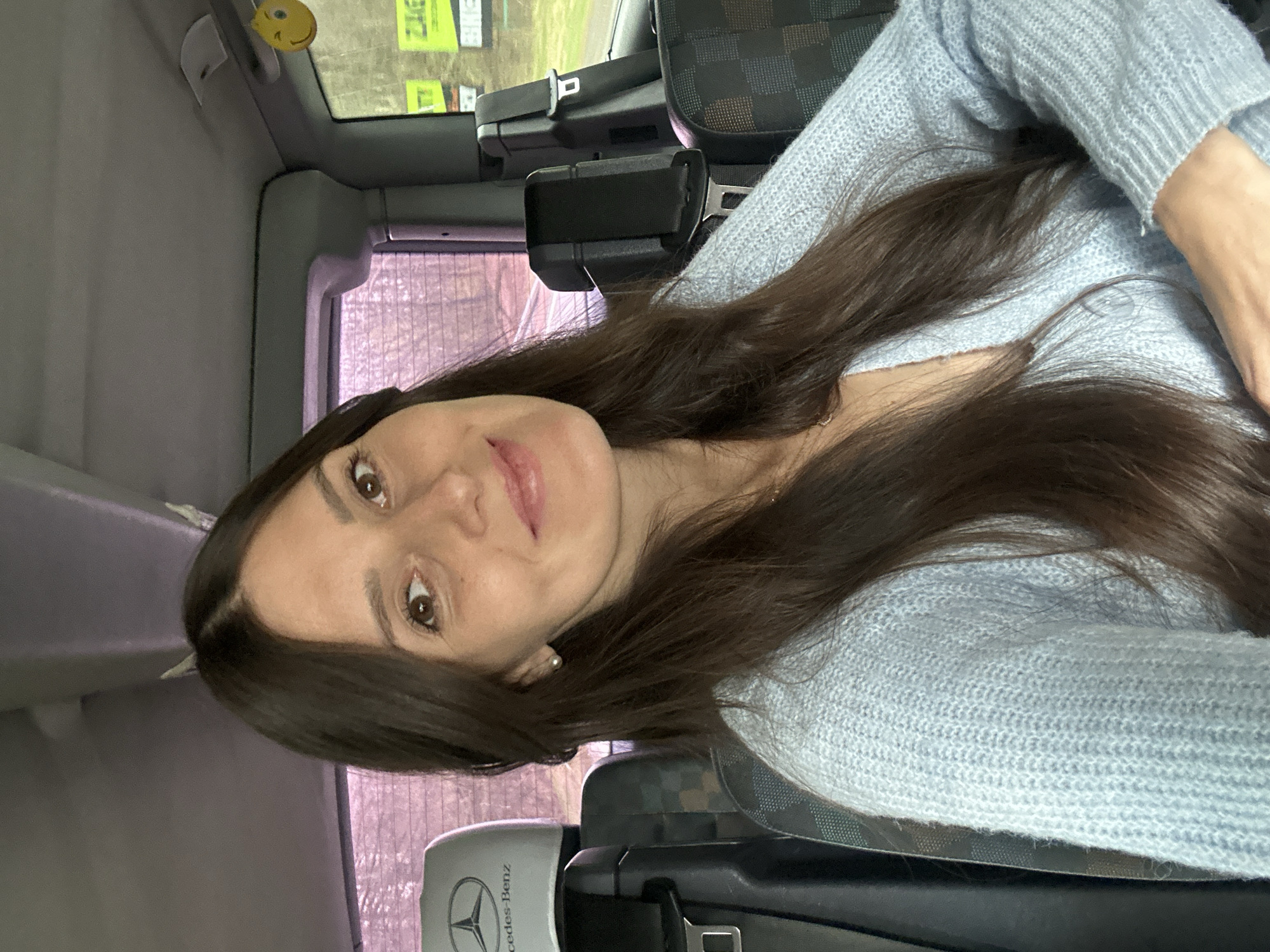 Woman in light blue sweater observed in Mercedes passenger seat