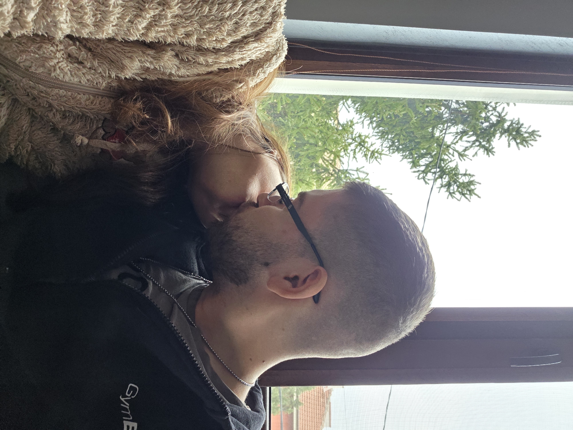 Man enjoys morning coffee by window in Bulgarian village