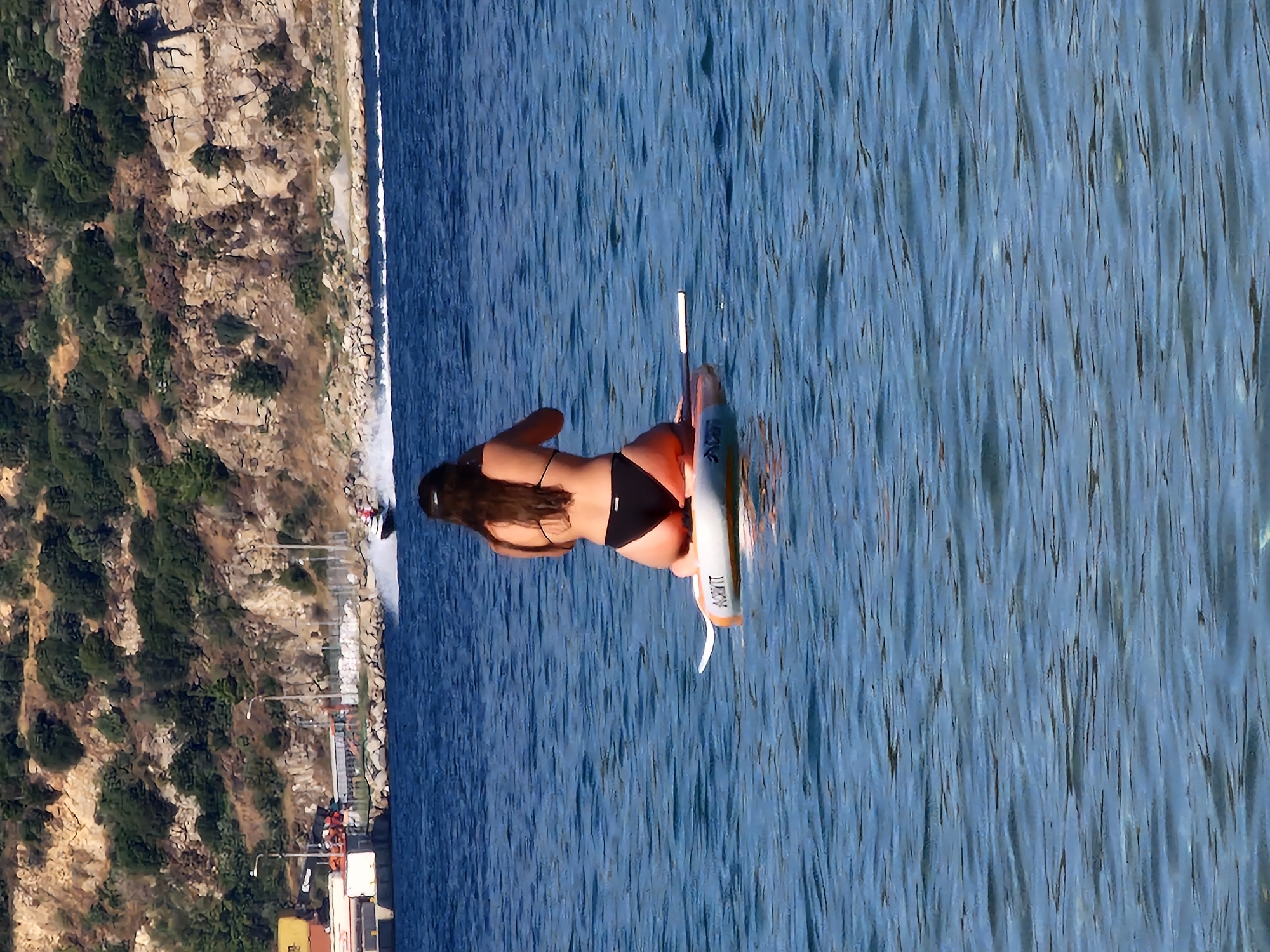 Boats and paddleboard on a Greek summer afternoon