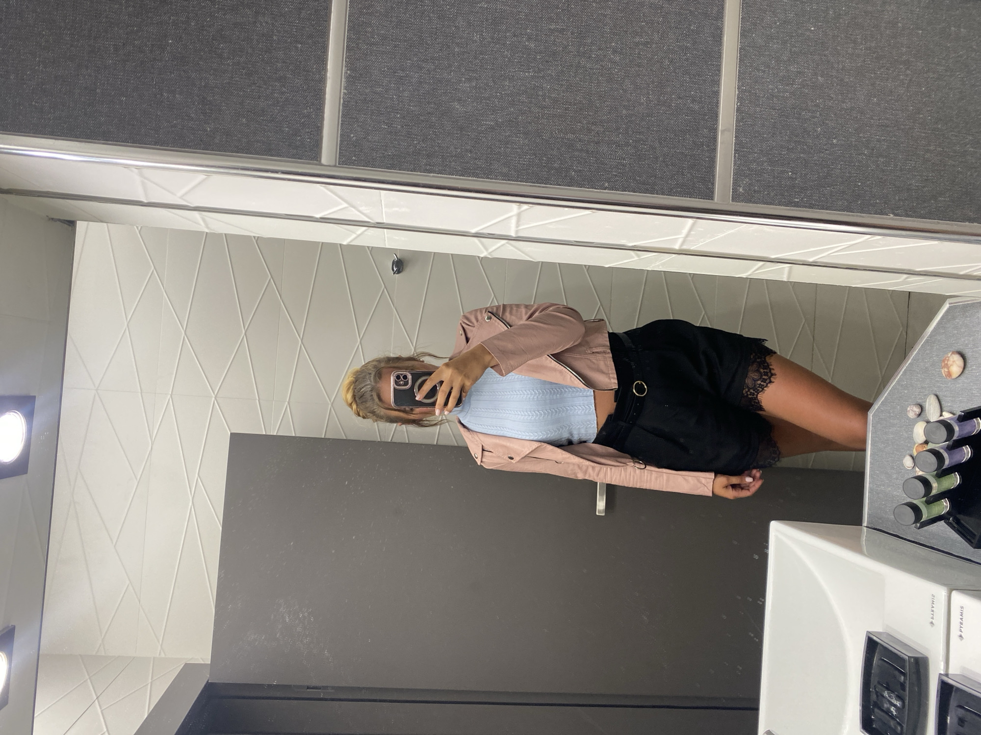Woman takes mirror selfies at Ofrynio Beach facility