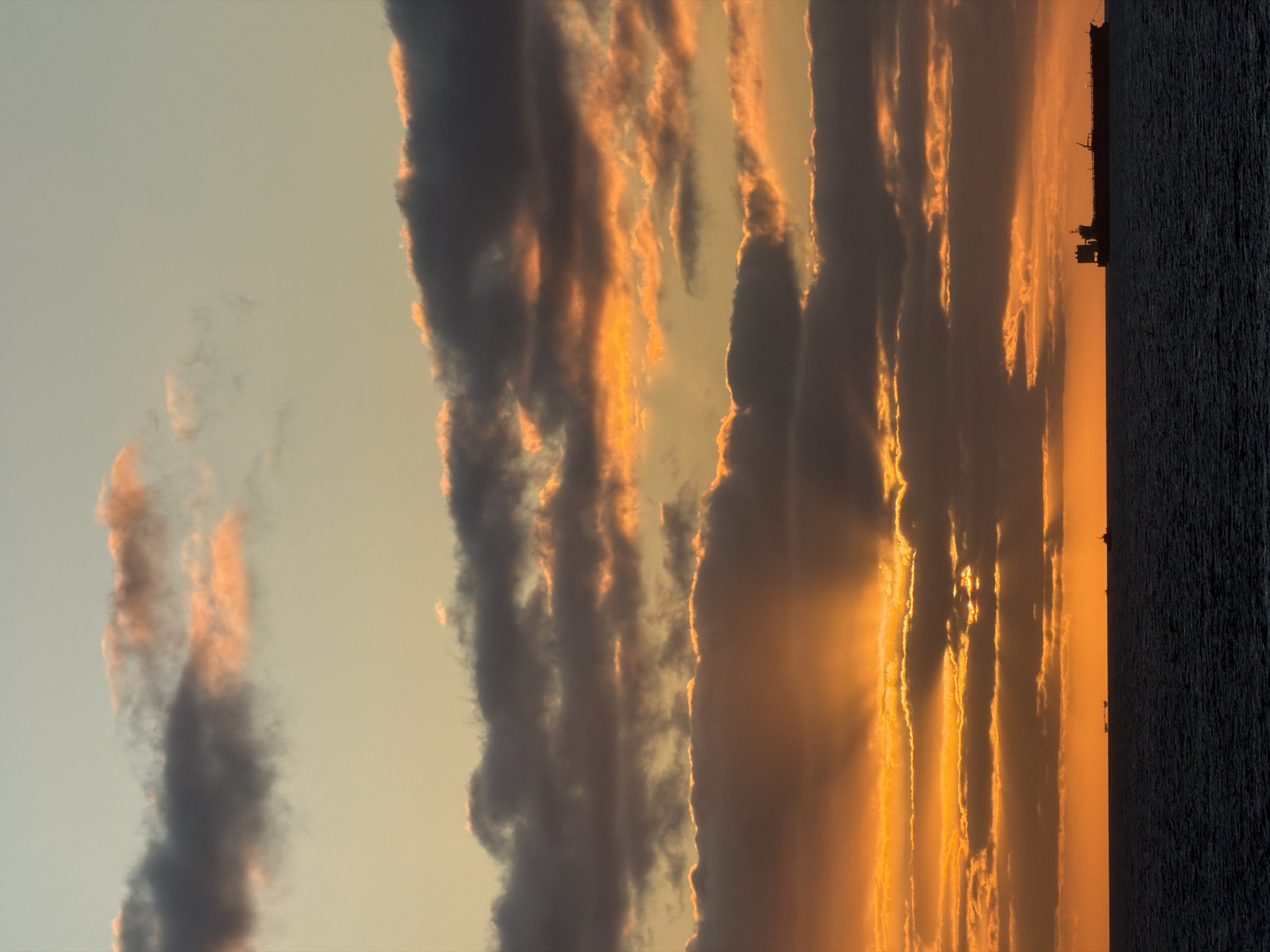 Ocean sunset with ship silhouette captured by witnesses