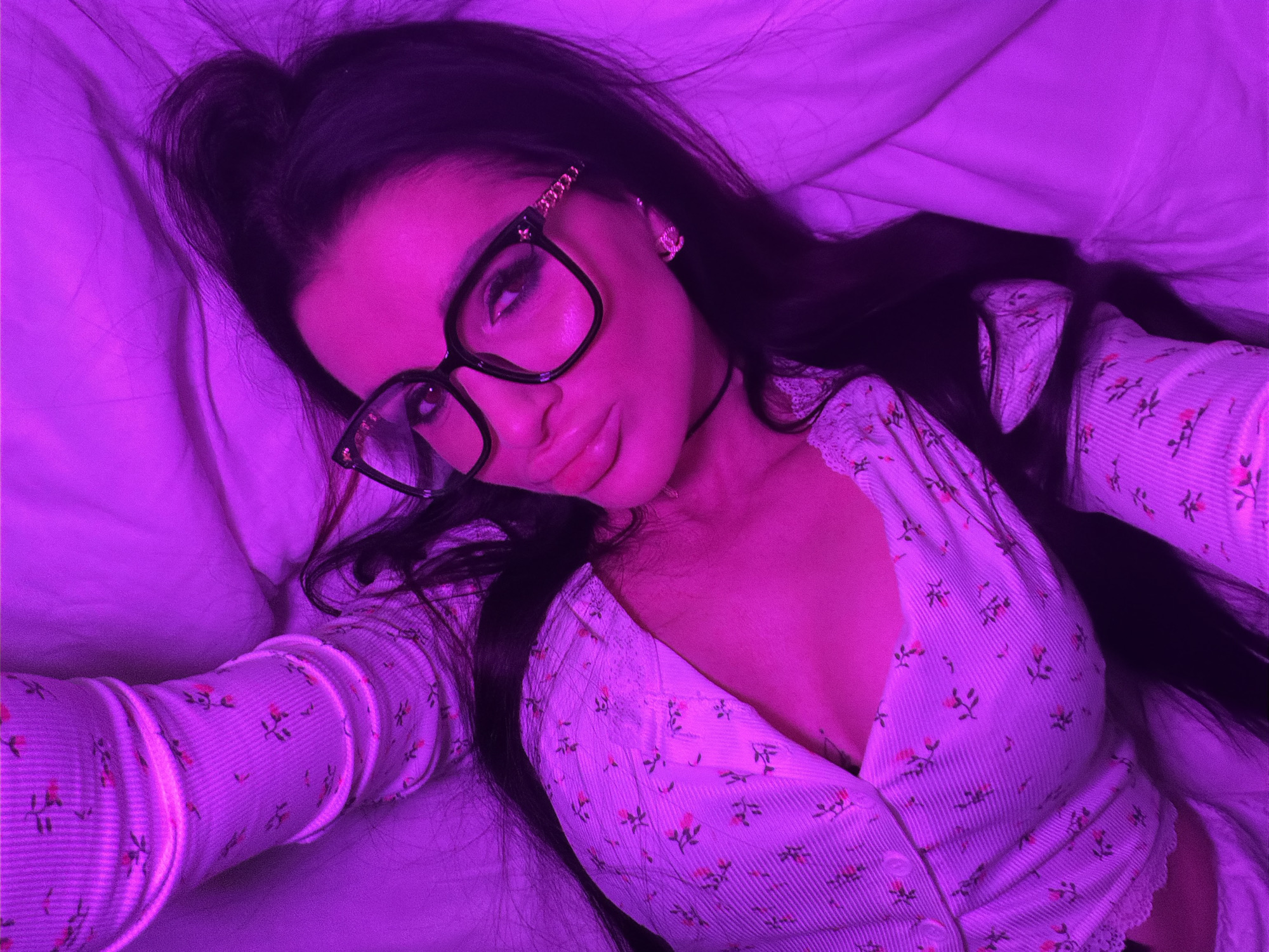 Woman takes selfies in purple-lit bedroom in Voronezh