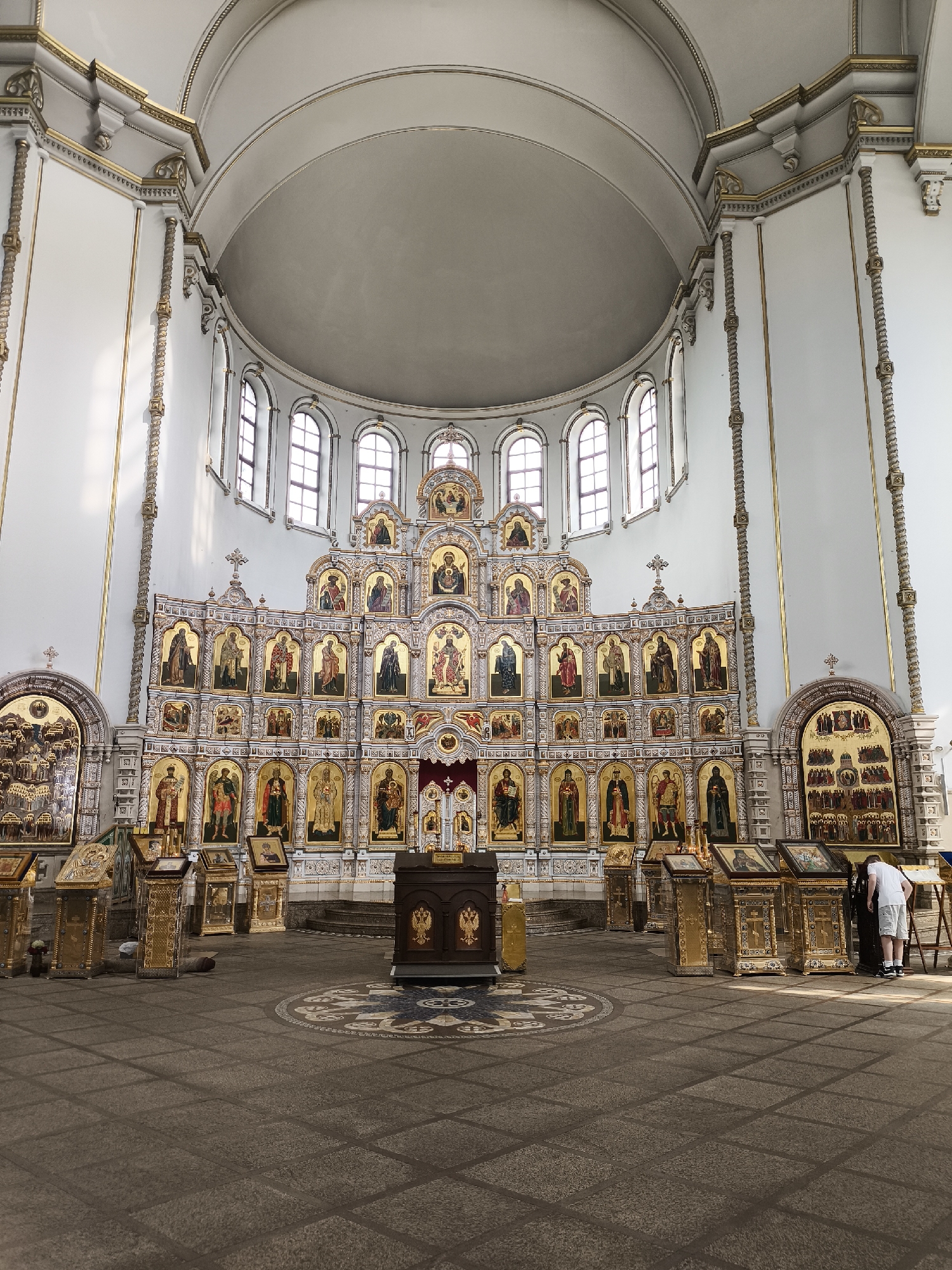 Inside an ornate Orthodox church, gilded and sun-lit