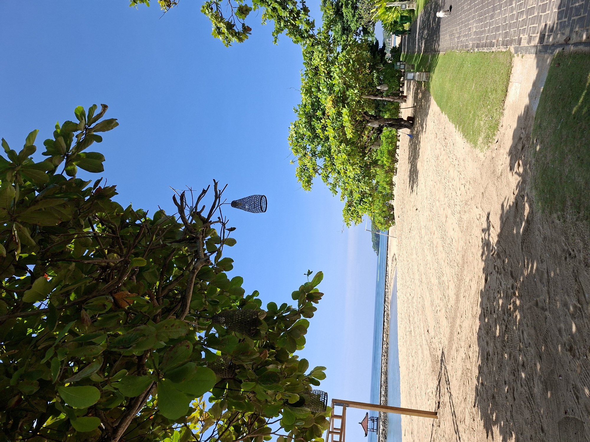 Tourist documents sunny morning at Kuta Selatan beach resort