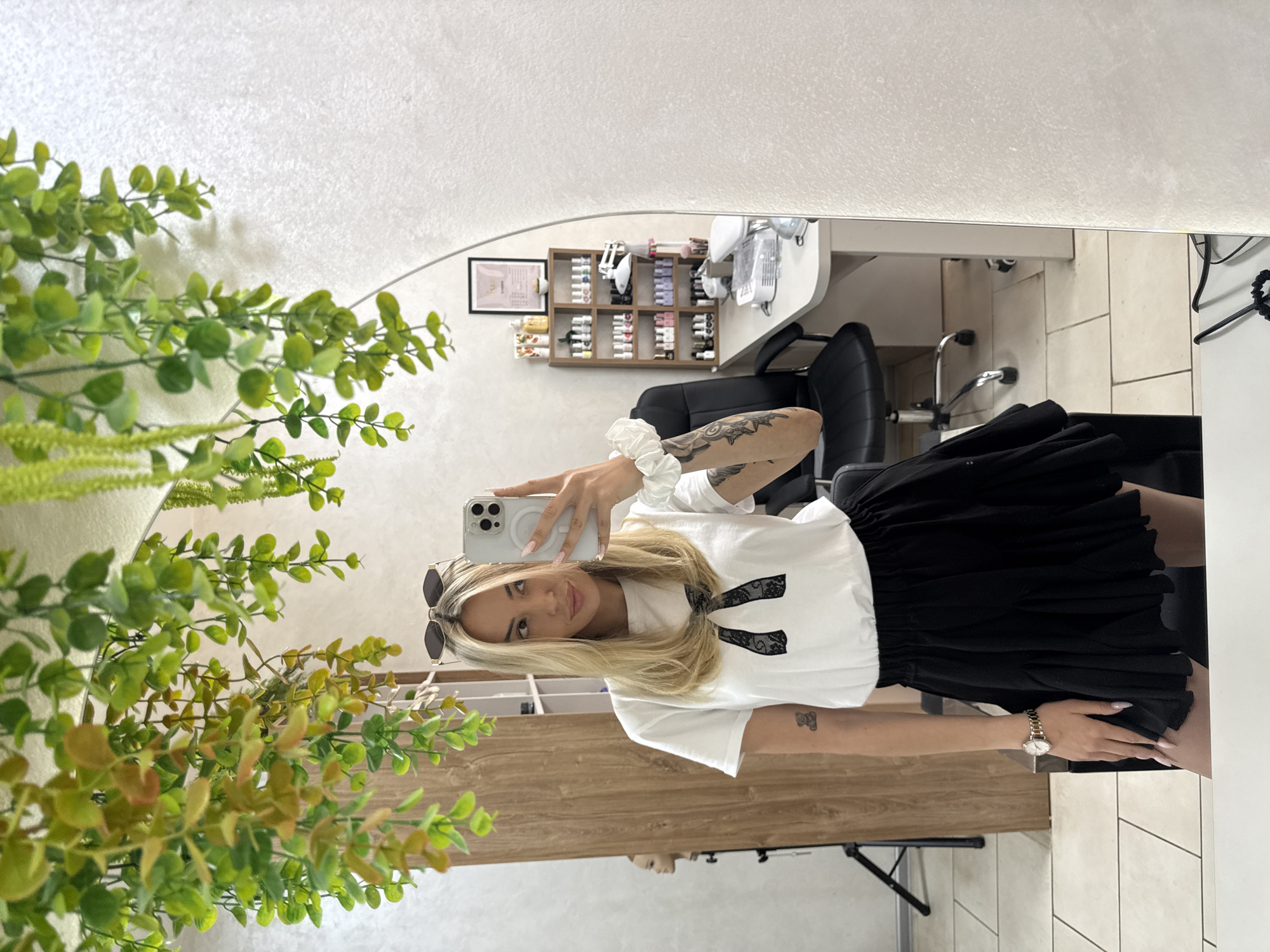 Woman takes mirror selfies at salon in Ruse, Bulgaria