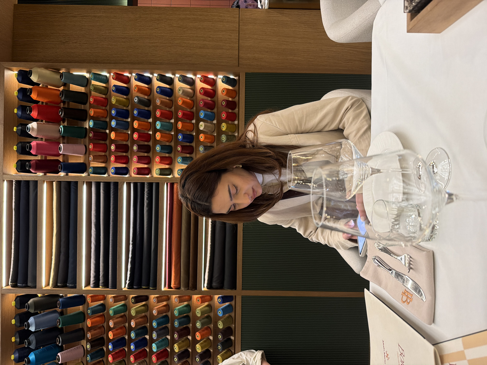 Woman seated at table in Yerevan fashion shop