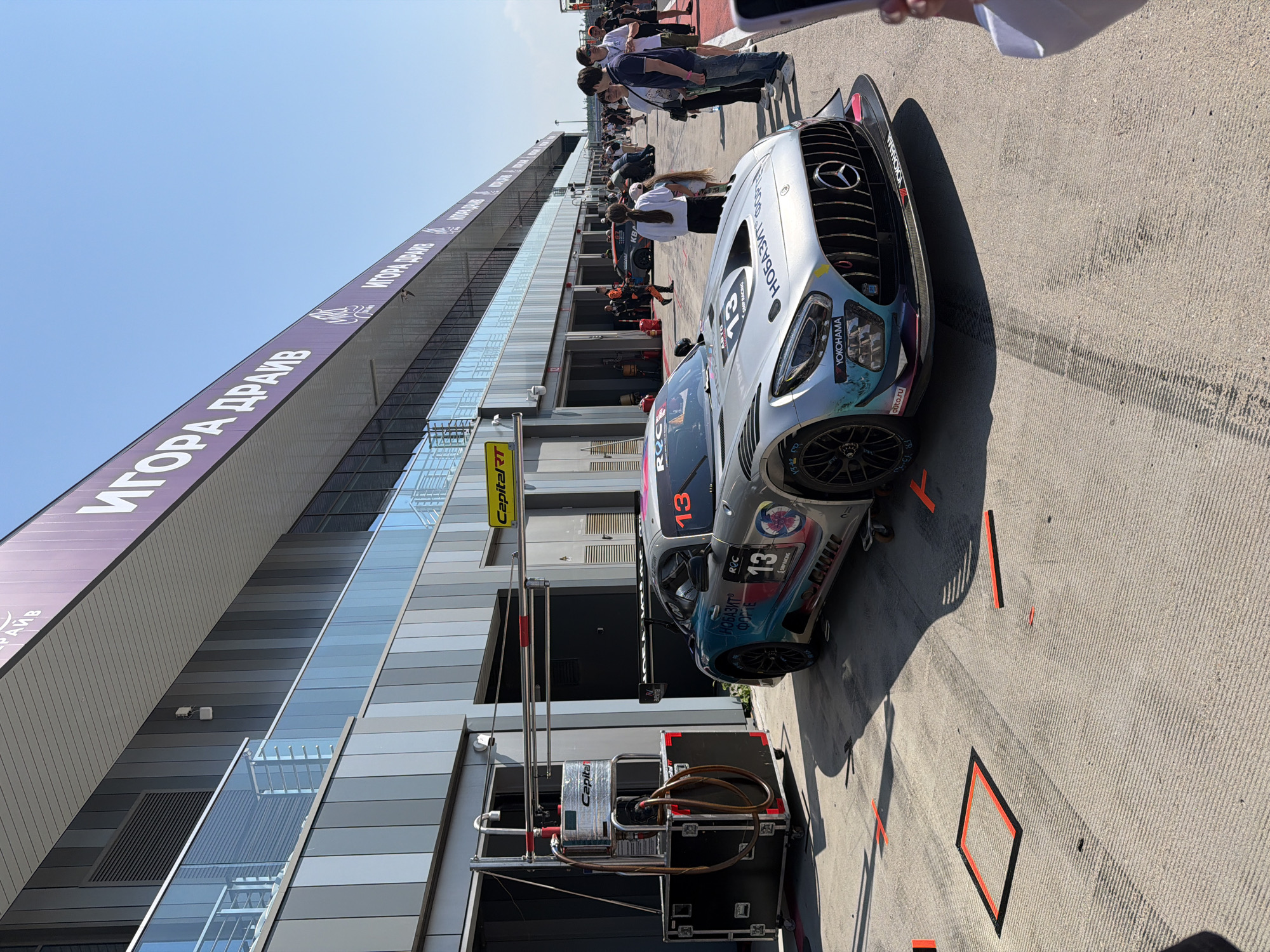 GT3 cars out at a sun-drenched race circuit